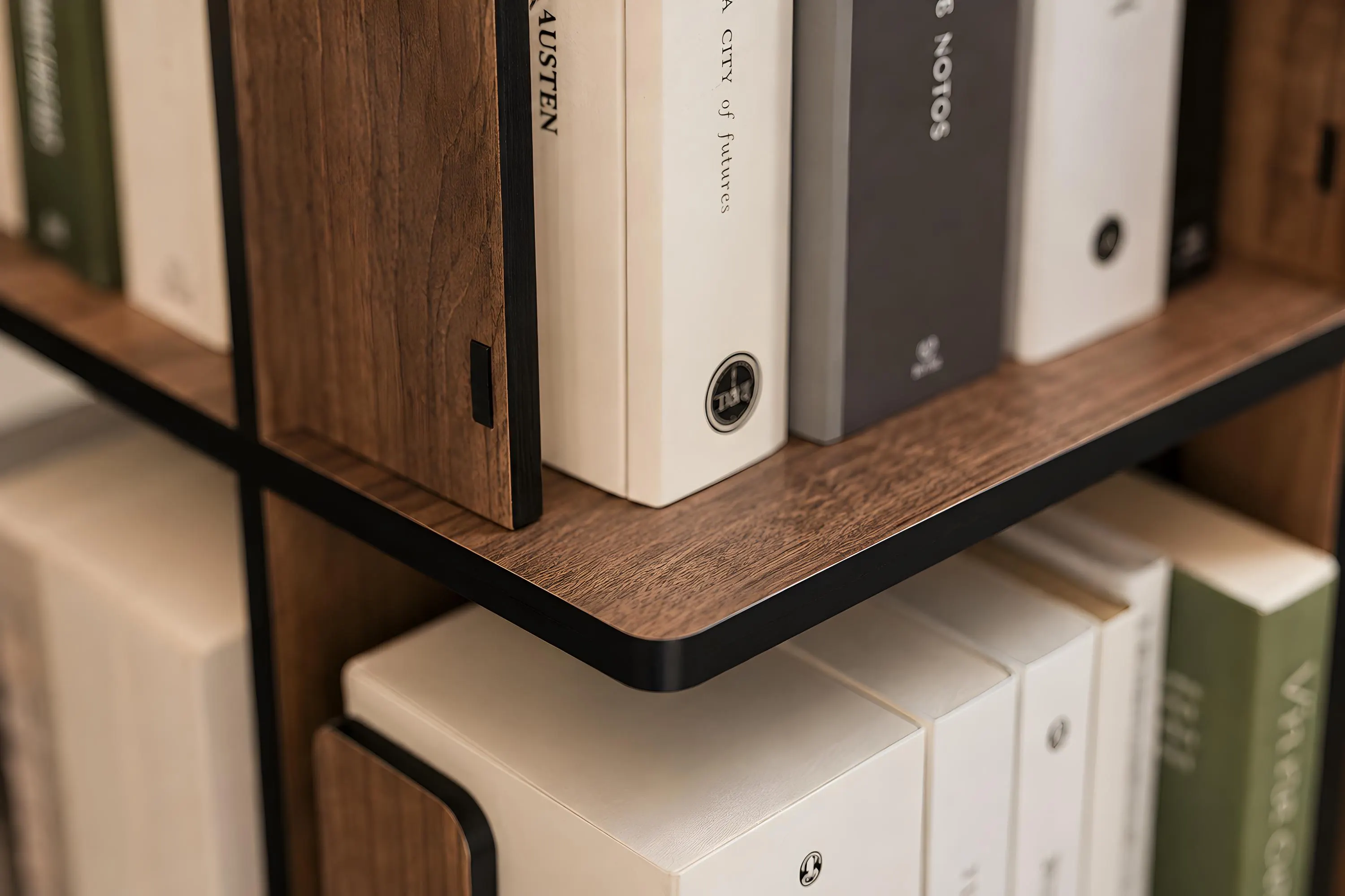 Close up of walnut wood rotating bookcase showing natural wood grain, black shelf edges and spacious book storage compartments