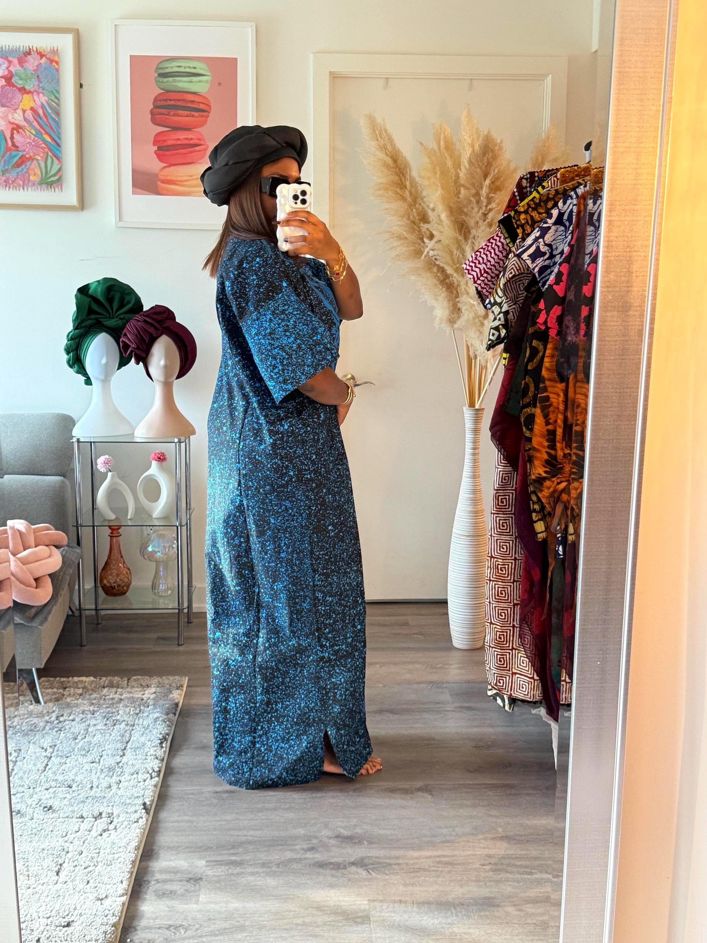 A long blue and black patterned dress with a side slit.
