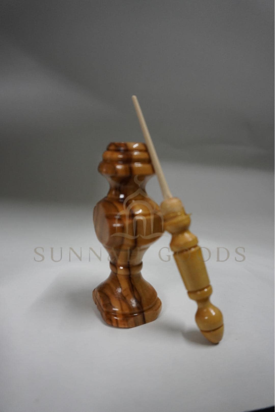Hand holding a kohl stick applicator ready for eyeliner application