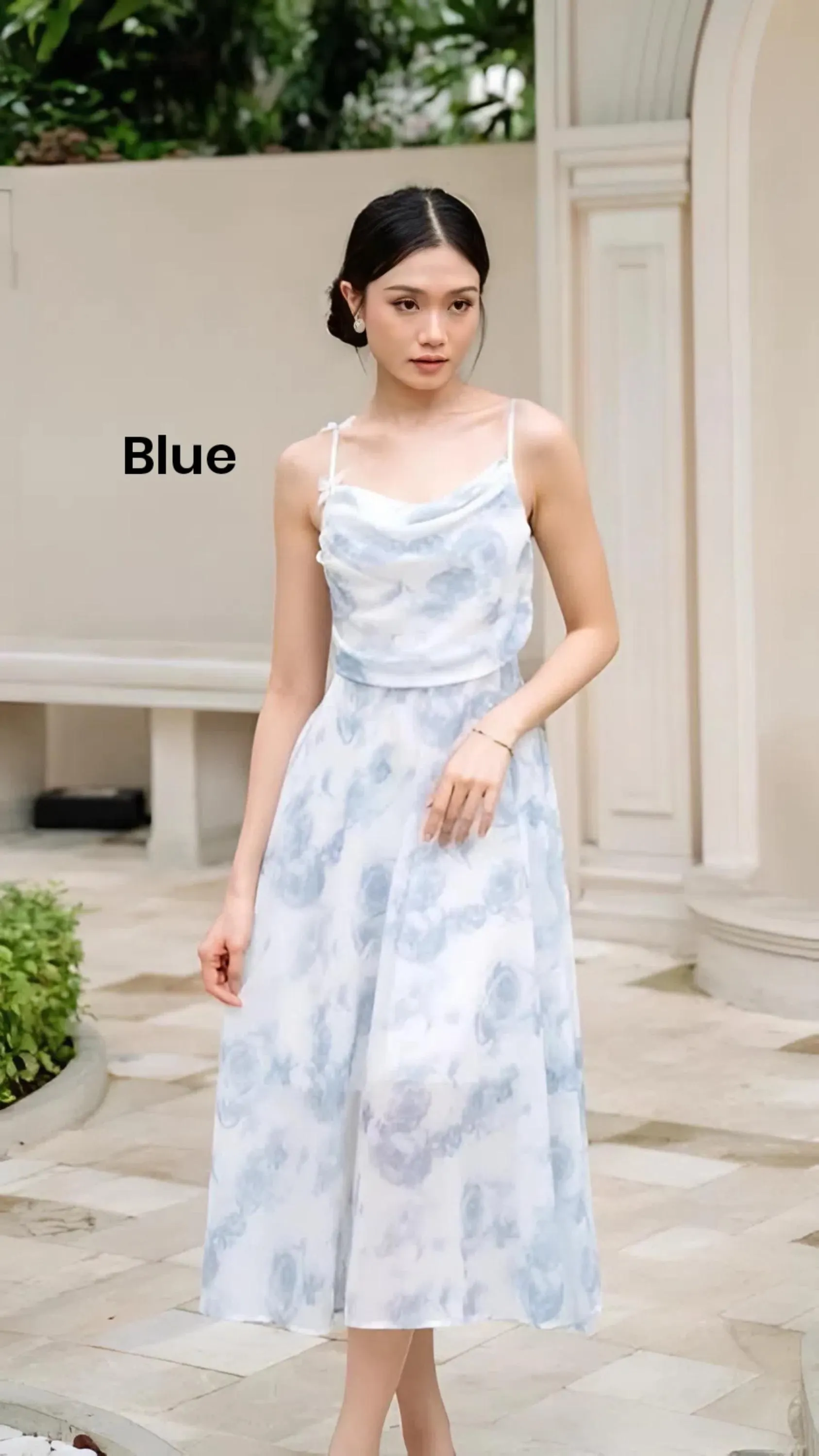 Women wearing a butterfly detail adjustable strap midi dress with elastic back and soft flowing fabric.