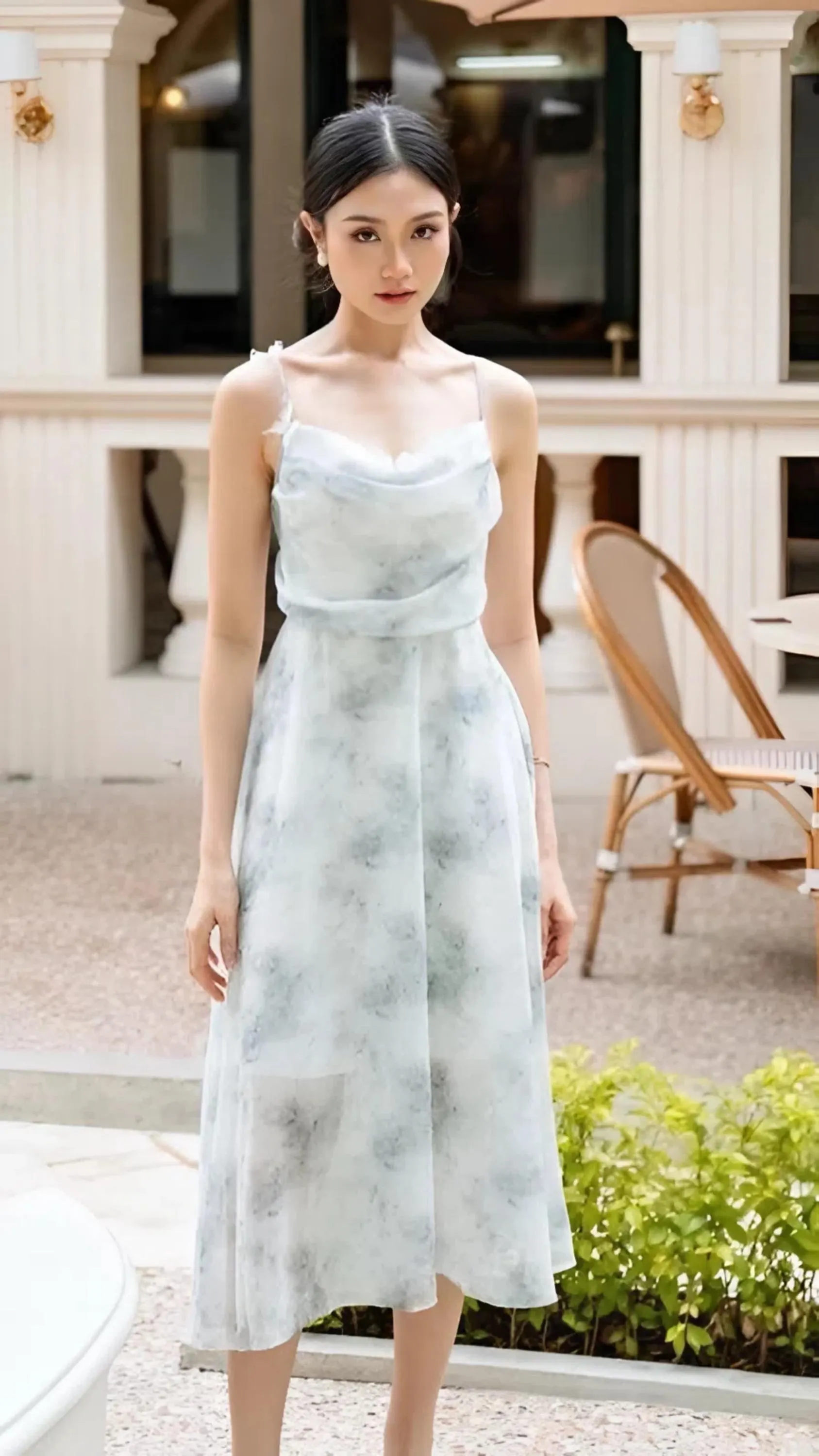 Women wearing a butterfly detail adjustable strap midi dress with elastic back and soft flowing fabric.