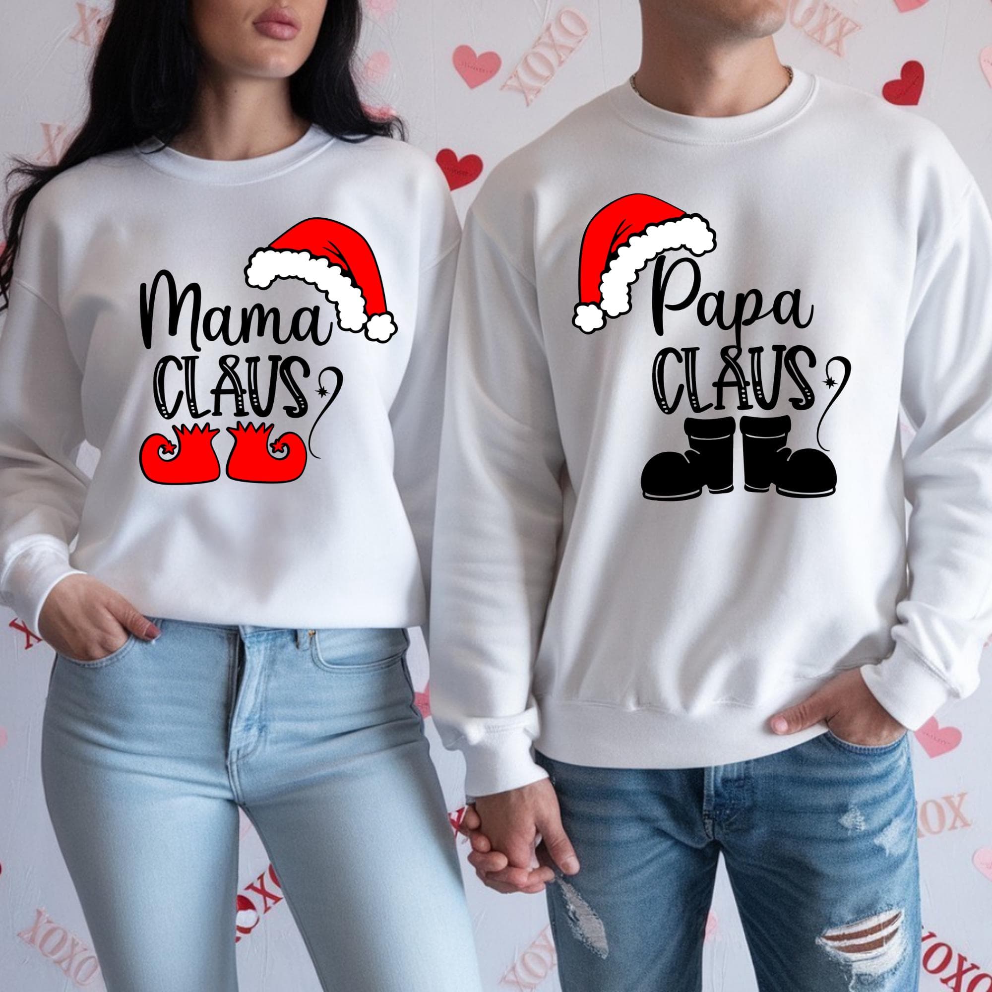 Two people wearing matching white sweatshirts with the text "Mama Claus?" and "Papa Claus?" printed on them, along with Santa Claus icons.
