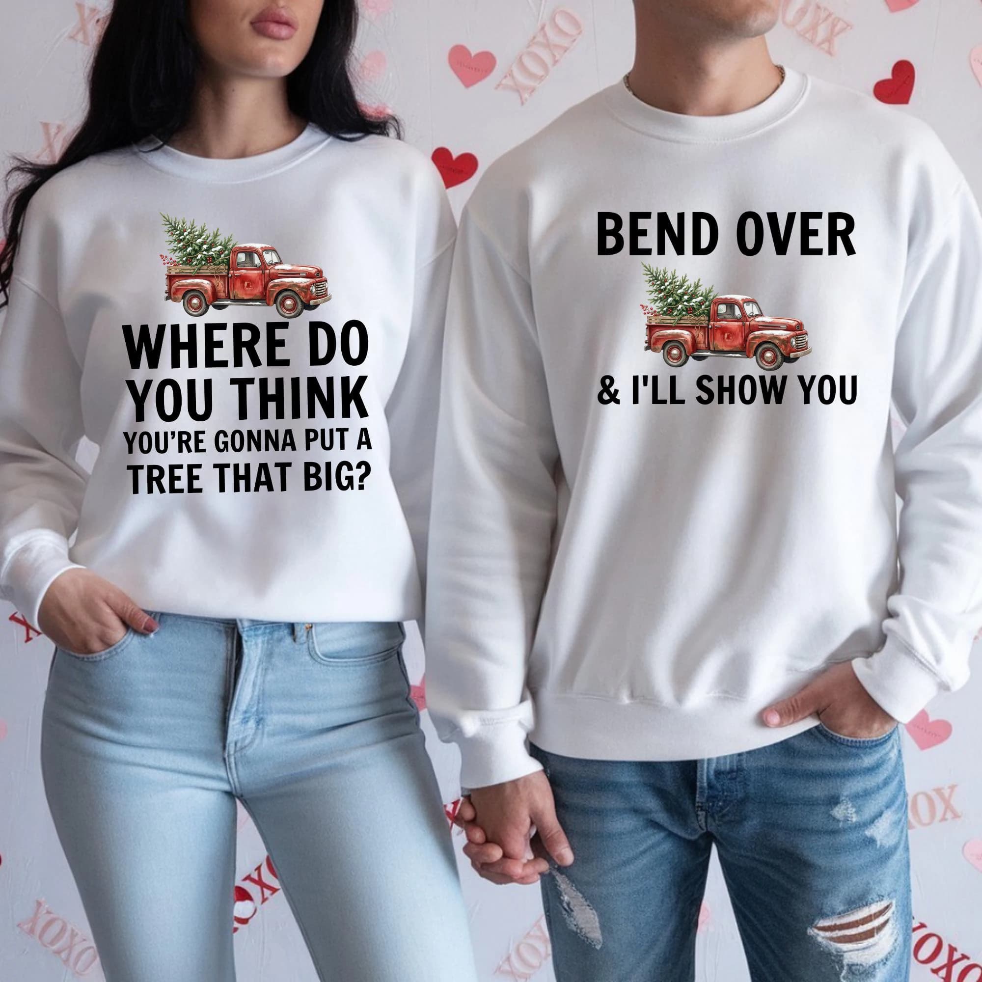 a man and a woman standing side by side, both wearing white sweatshirts with humorous text and graphics.