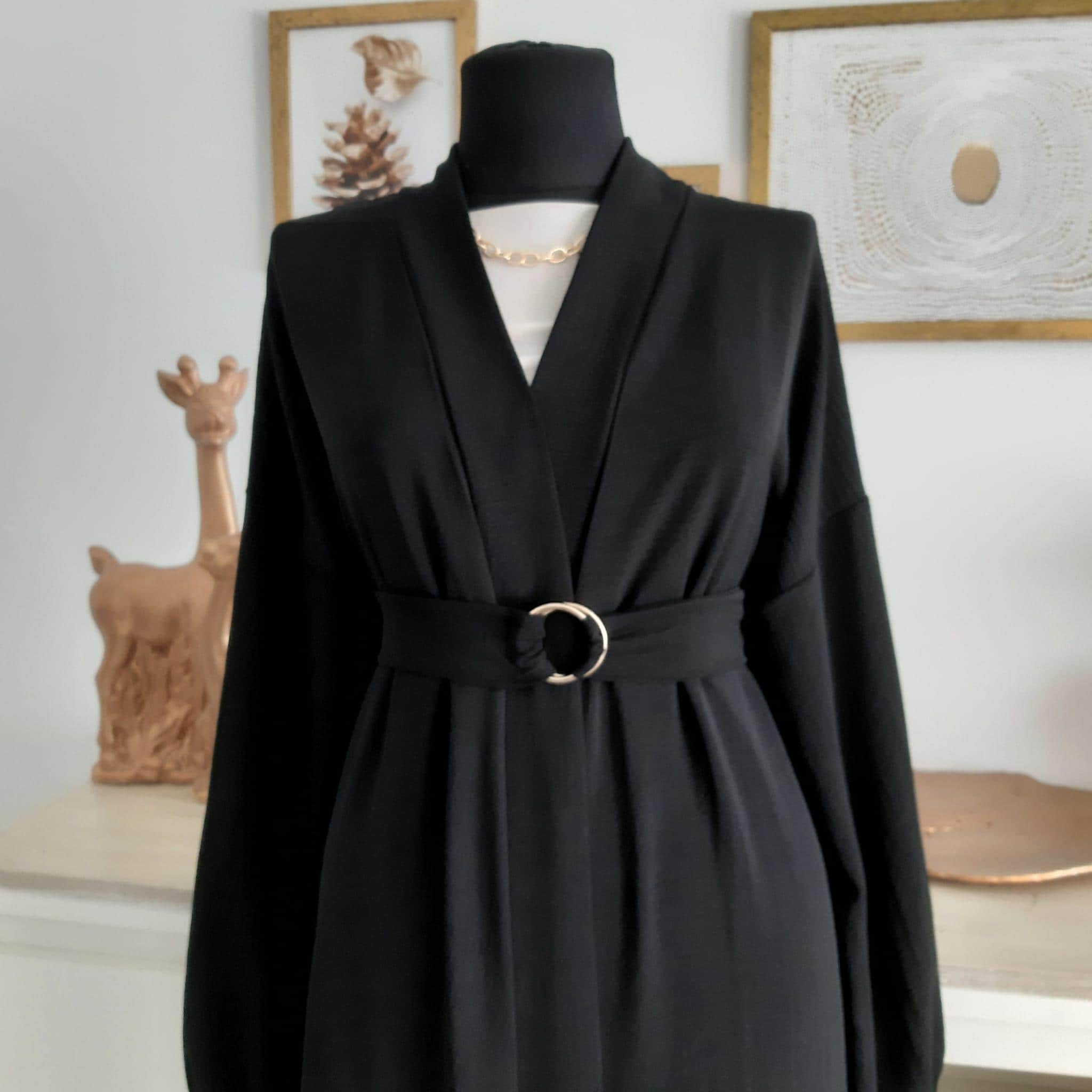 abaya-with-accessory-belt-gold-detail Stylish abaya with a unique accessory belt and gold detailing for a luxurious touch.
