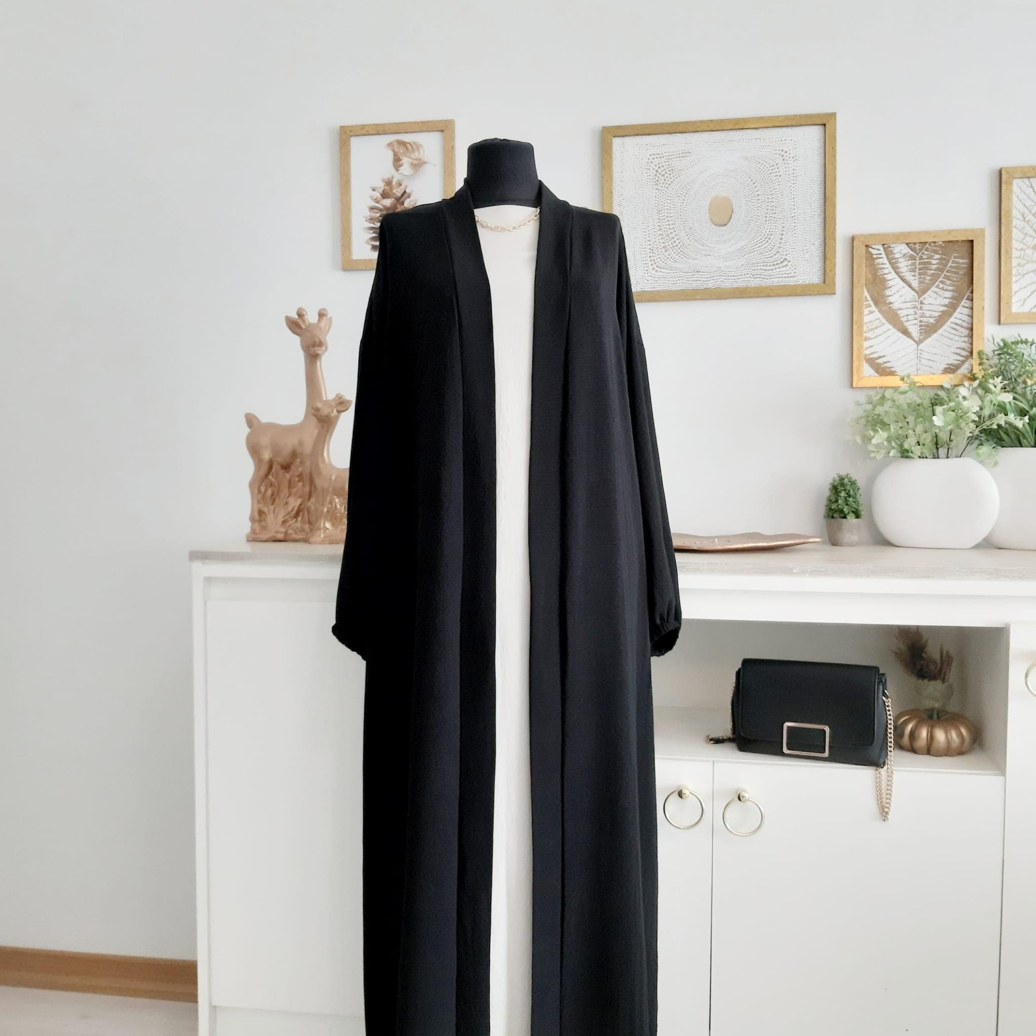 modest-overcoat-black-crepe-dress Flowy black crepe modest overcoat ideal for layering in everyday Muslim fashion.