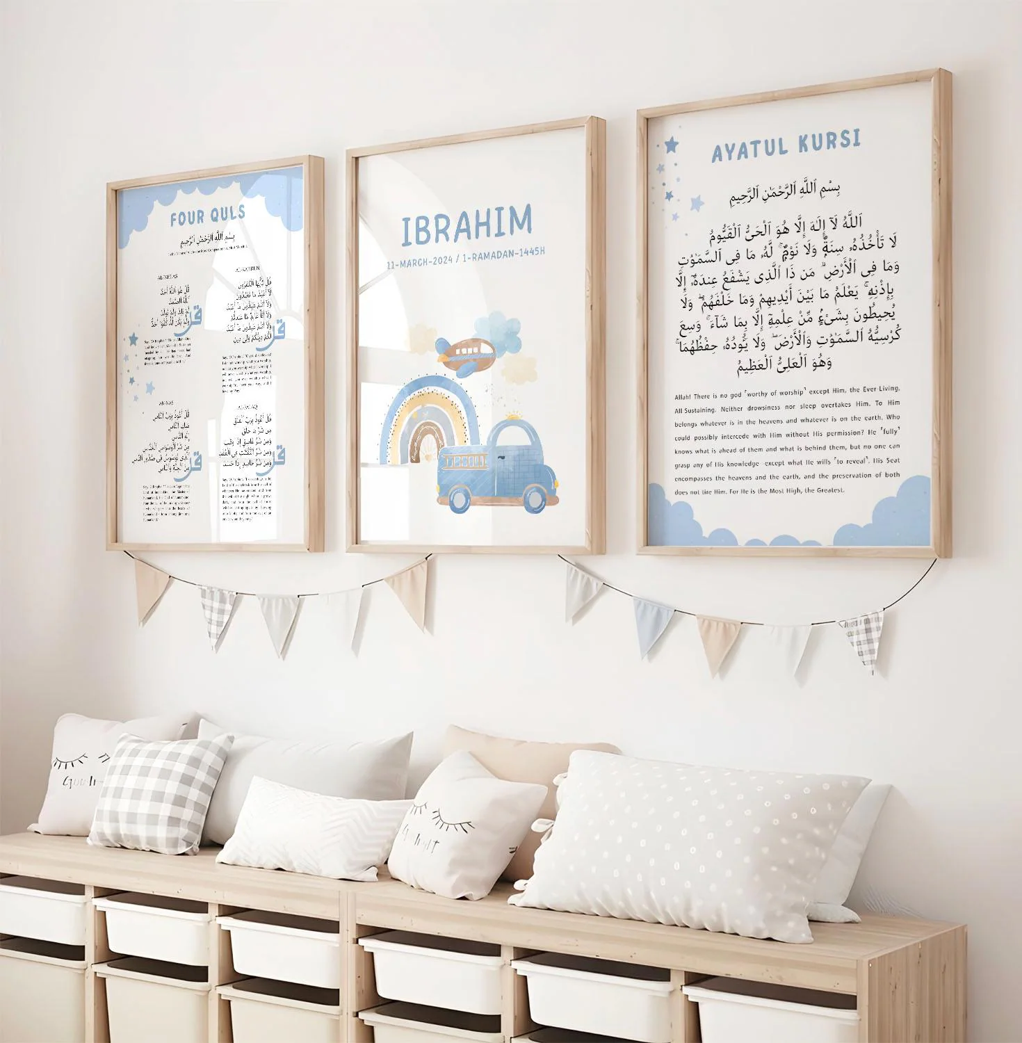 May include: Three framed prints with light blue and beige accents hang above a wooden bench with storage bins. The prints feature Arabic text and illustrations of a rainbow, airplane, and car. A garland of triangular flags hangs below the prints.