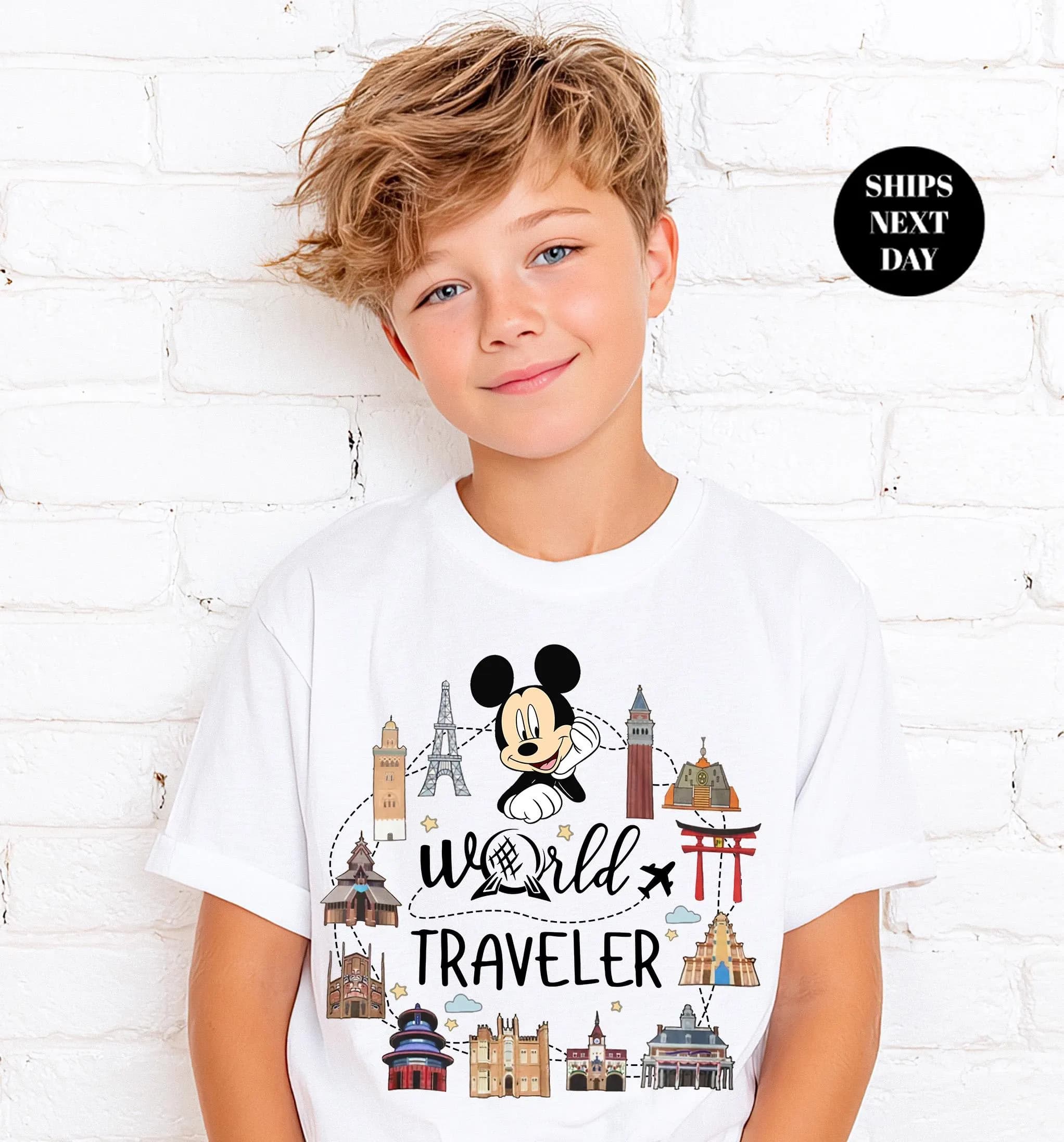 A young boy wearing a white t-shirt with a Mickey Mouse design and the text "World Traveler" printed on it.