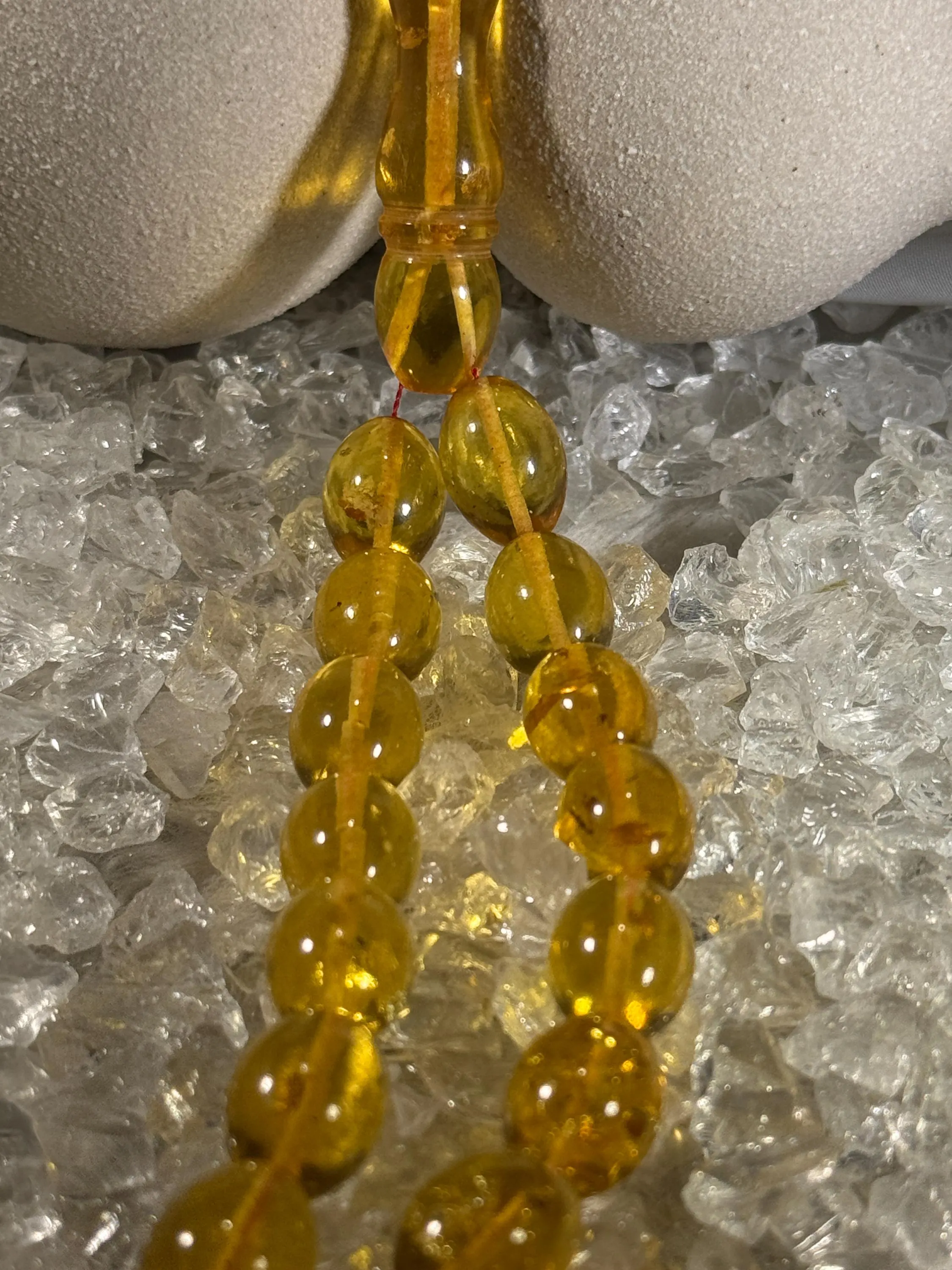 Close-up of natural amber beads with unique texture and polished surface – premium handmade prayer rosary