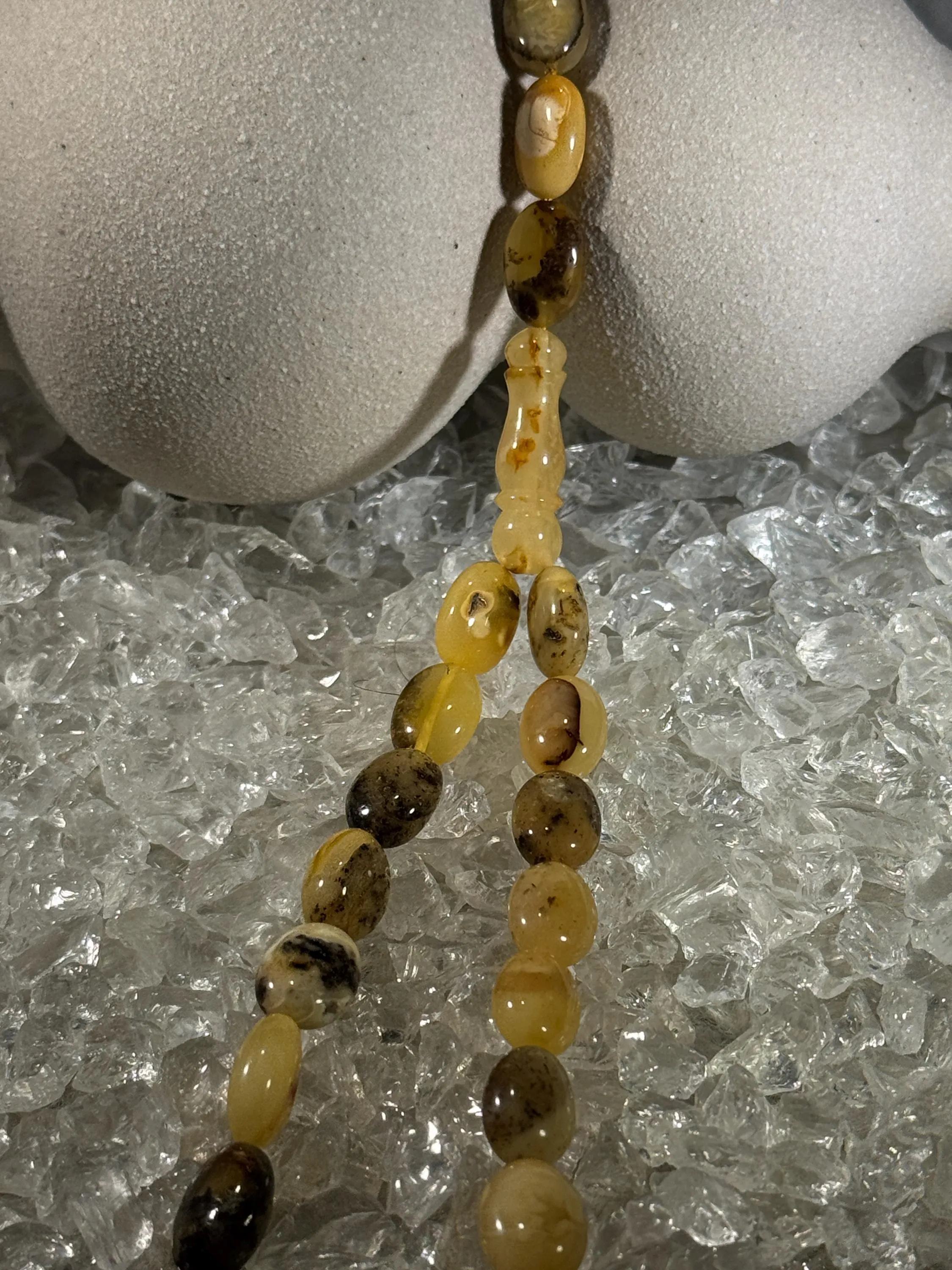 Close-up of natural amber beads with unique texture and polished surface – premium handmade prayer rosary