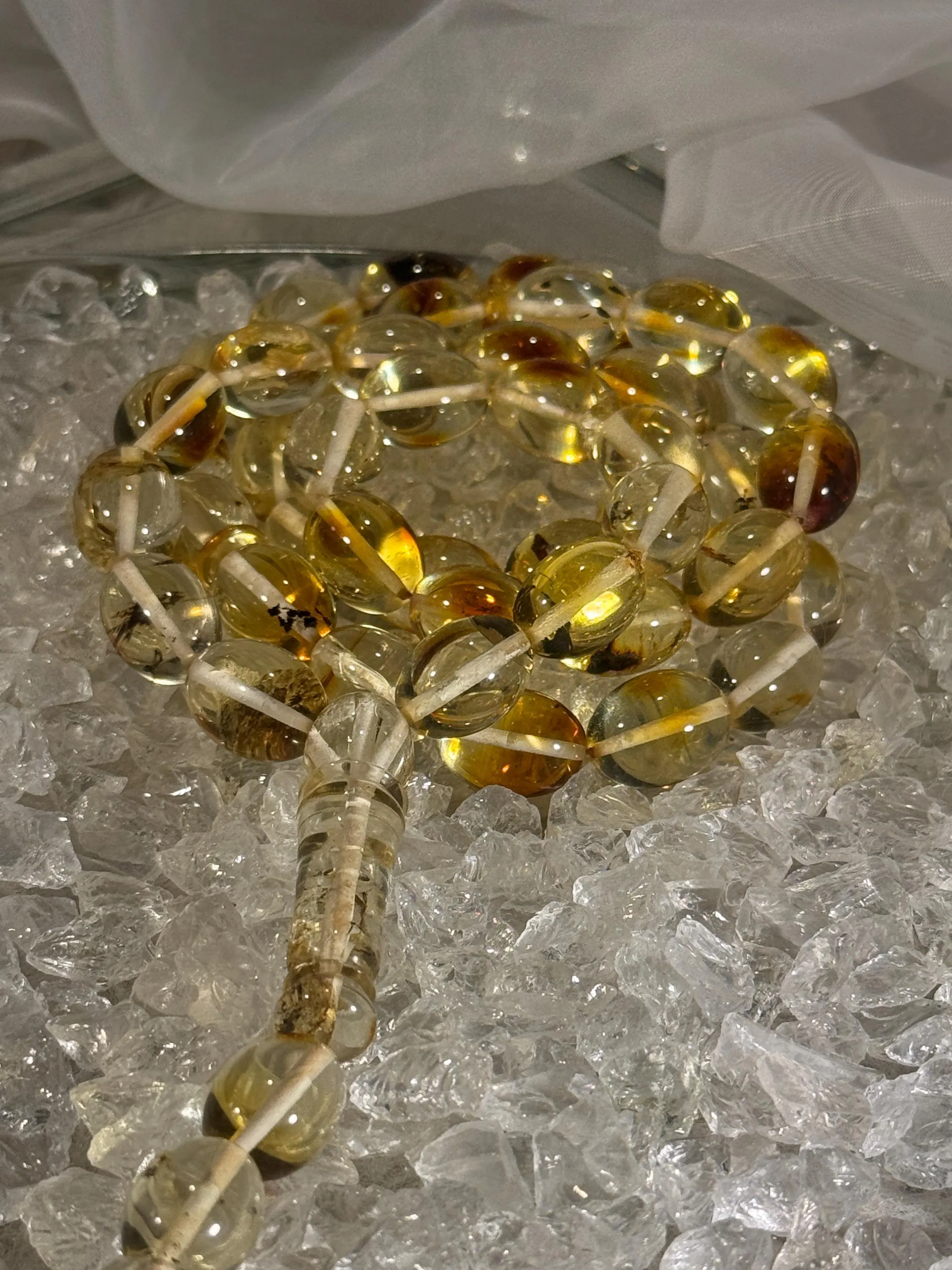 Close-up of natural amber beads with unique texture and polished surface – premium handmade prayer rosary