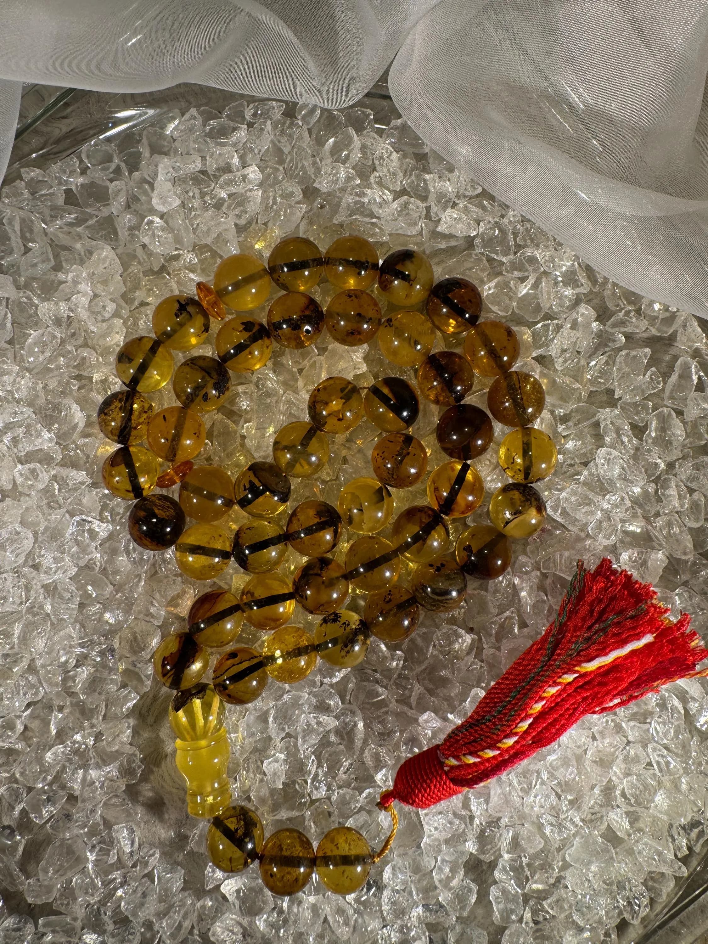 Close-up of natural amber beads with unique texture and polished surface – premium handmade prayer rosary