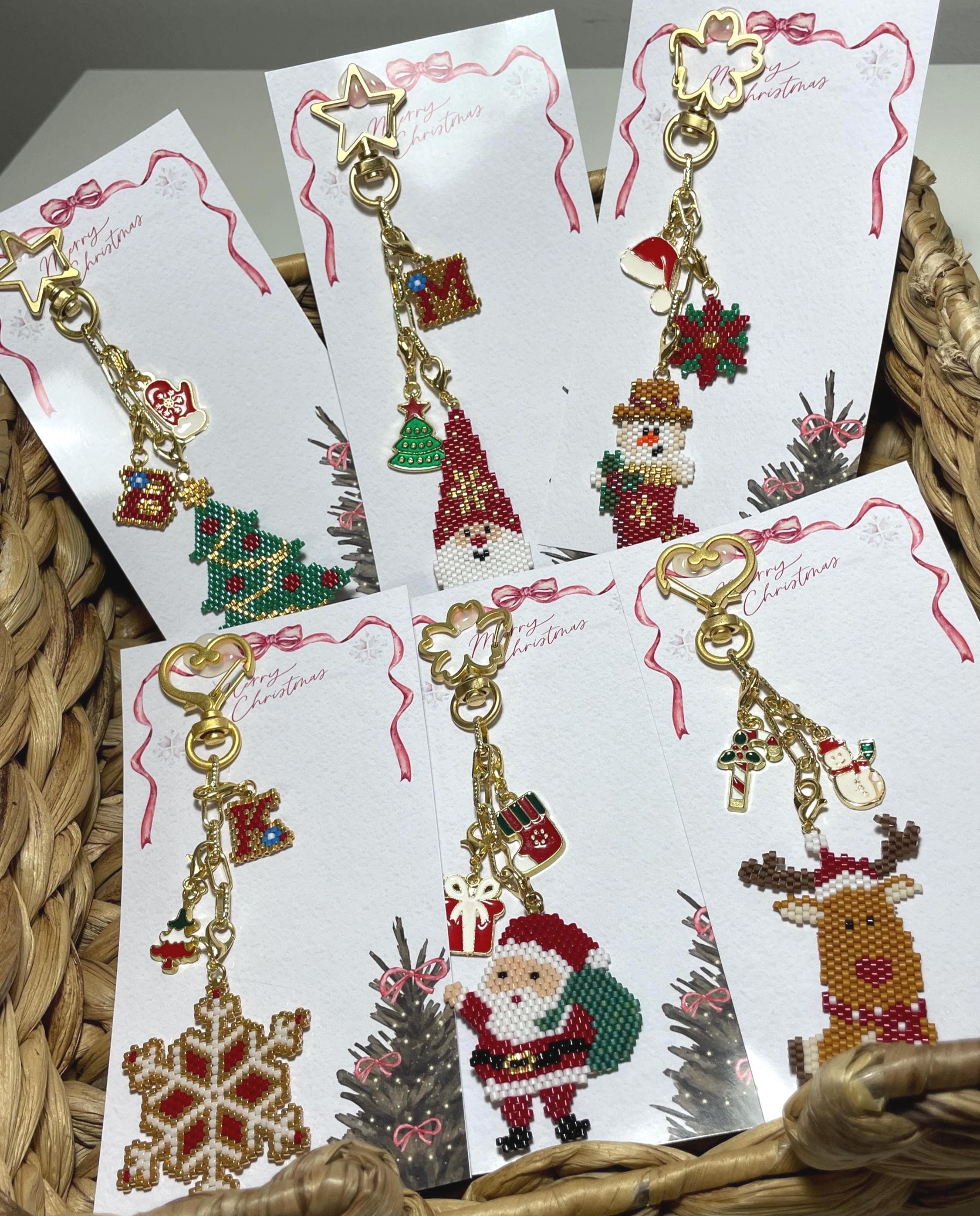 Bring holiday cheer wherever you go with this handmade beaded Christmas Santa & pine tree ornament! Perfect as a keychain, bag accessory, or meaningful gift for loved ones. The design features a Santa Claus, pine tree, and a matching mini gift ornament, all with festive red, green, gold, and white details.