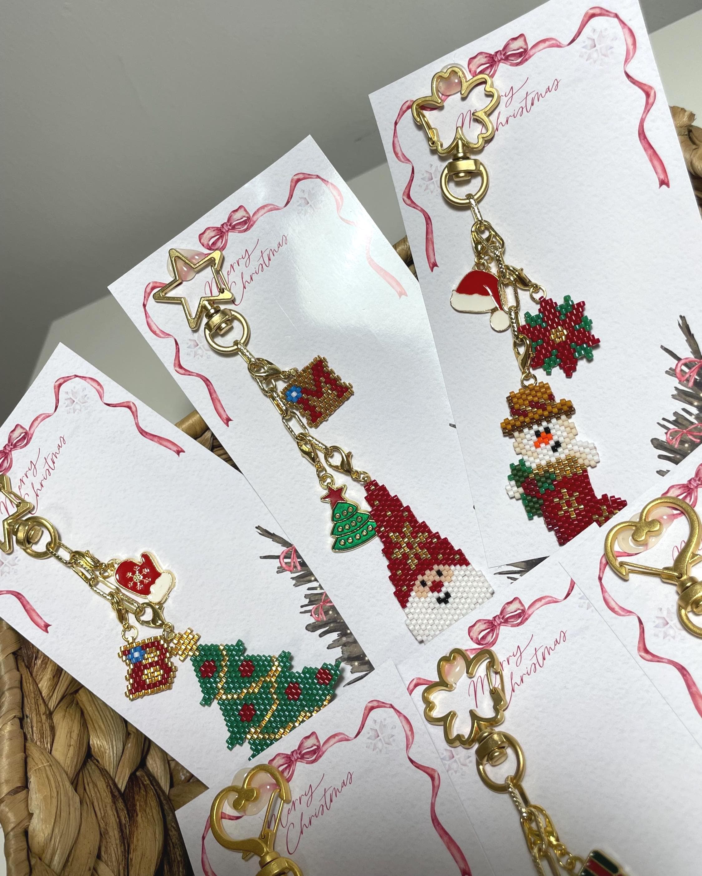 Bring holiday cheer wherever you go with this handmade beaded Christmas Santa & pine tree ornament! Perfect as a keychain, bag accessory, or meaningful gift for loved ones. The design features a Santa Claus, pine tree, and a matching mini gift ornament, all with festive red, green, gold, and white details.