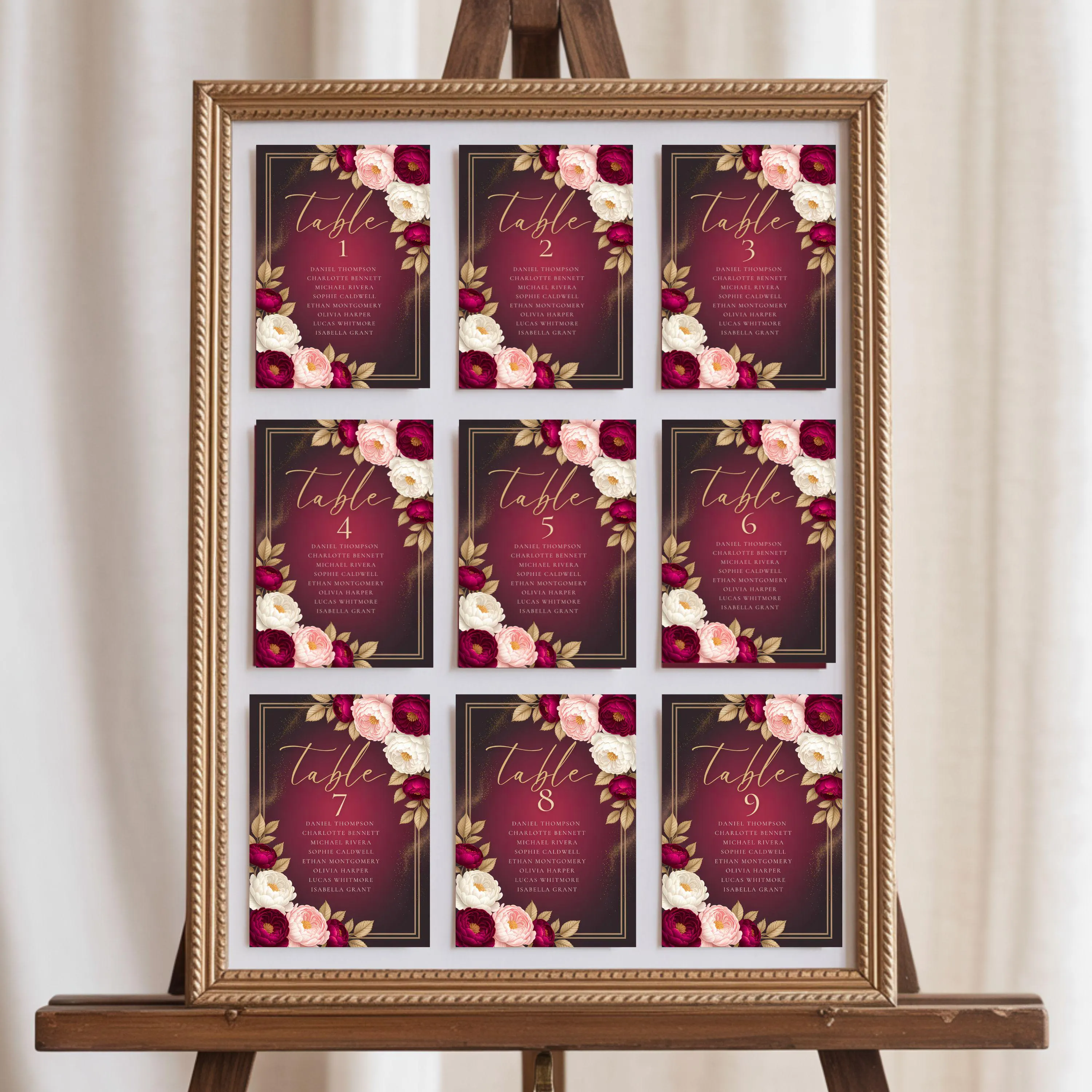 Elegant burgundy event seating chart with nine 5x7 cards arranged in grid inside gold frame on easel.