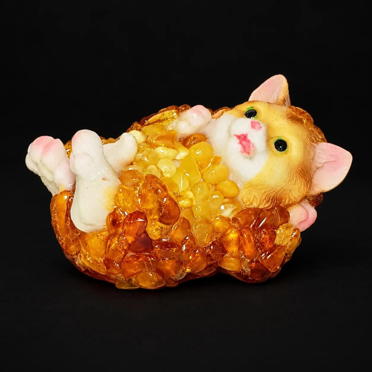 Made in USA Natural Baltic Amber cat figurine lying on its back with raised paws, amber mosaic kitten, black studio background — KIZIMA®