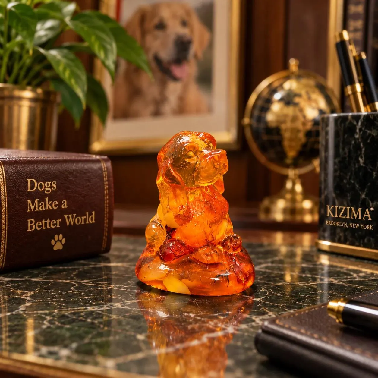 Made in USA natural Baltic amber Cocker Spaniel figurine as desk decor beside a globe, fountain pen and KIZIMA® Brooklyn gift box — spaniel lover gift