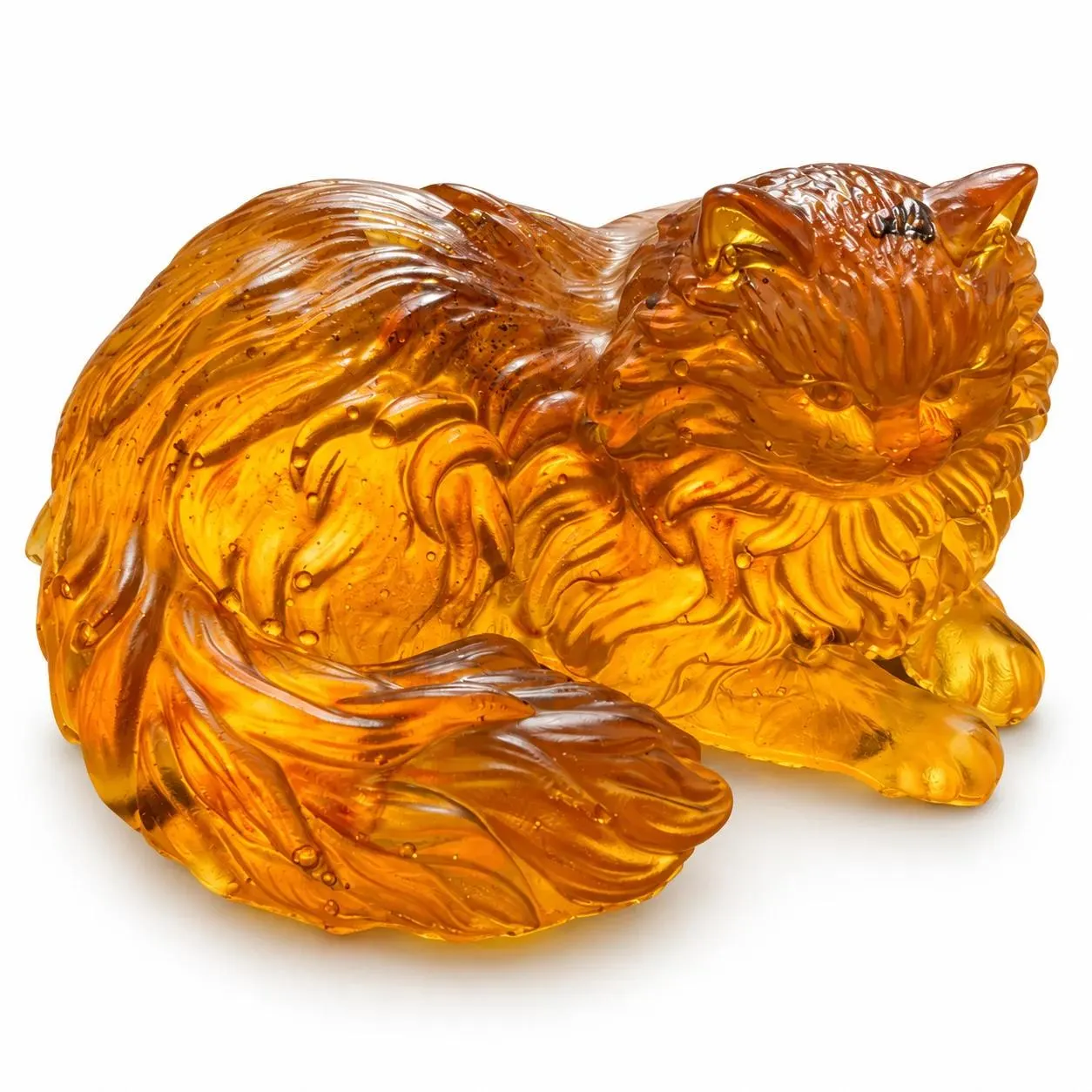 Golden Persian cat figurine with detailed long fur, forward paws and a curved plume tail on a white studio background