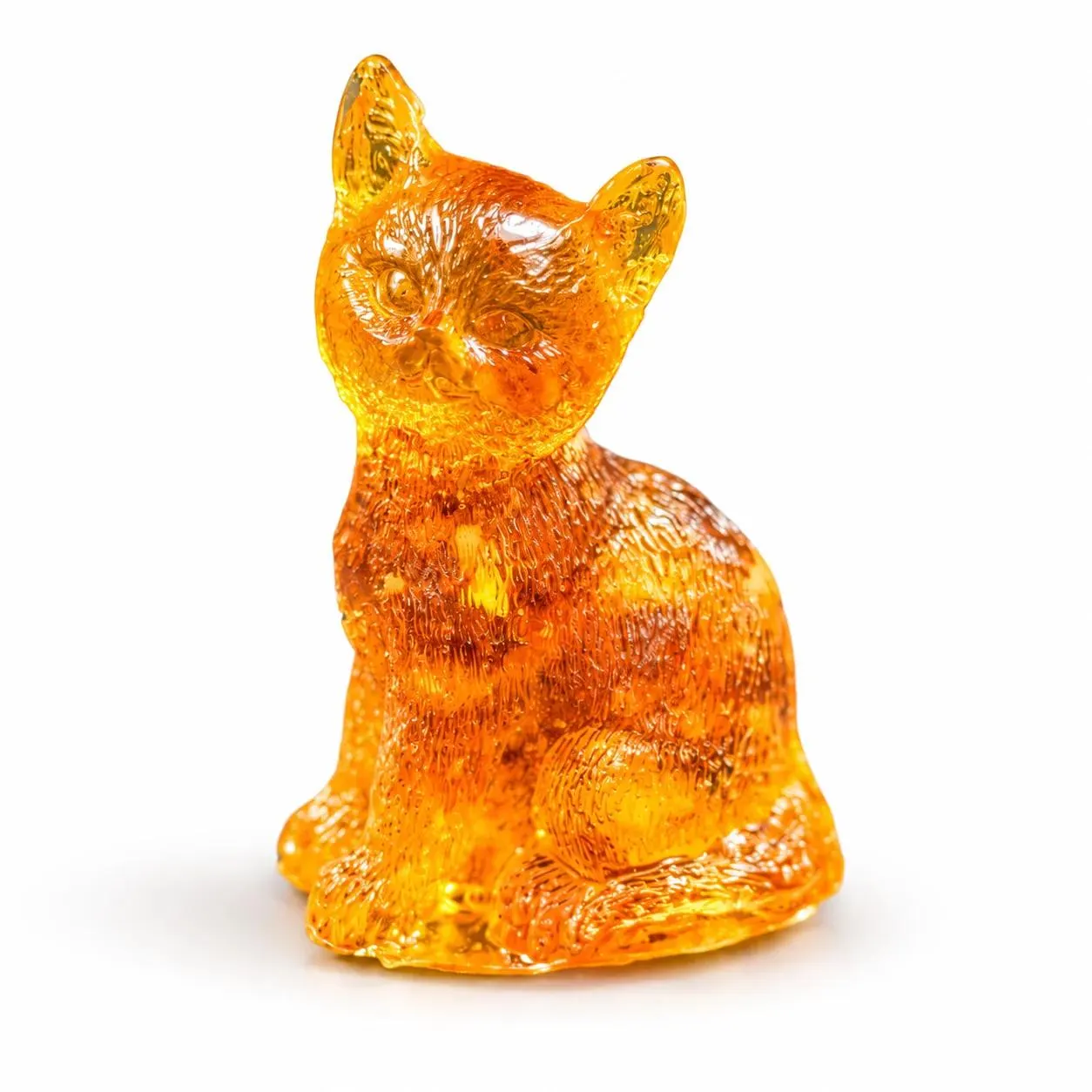 Mini sitting cat figurine on white background, 4 cm high