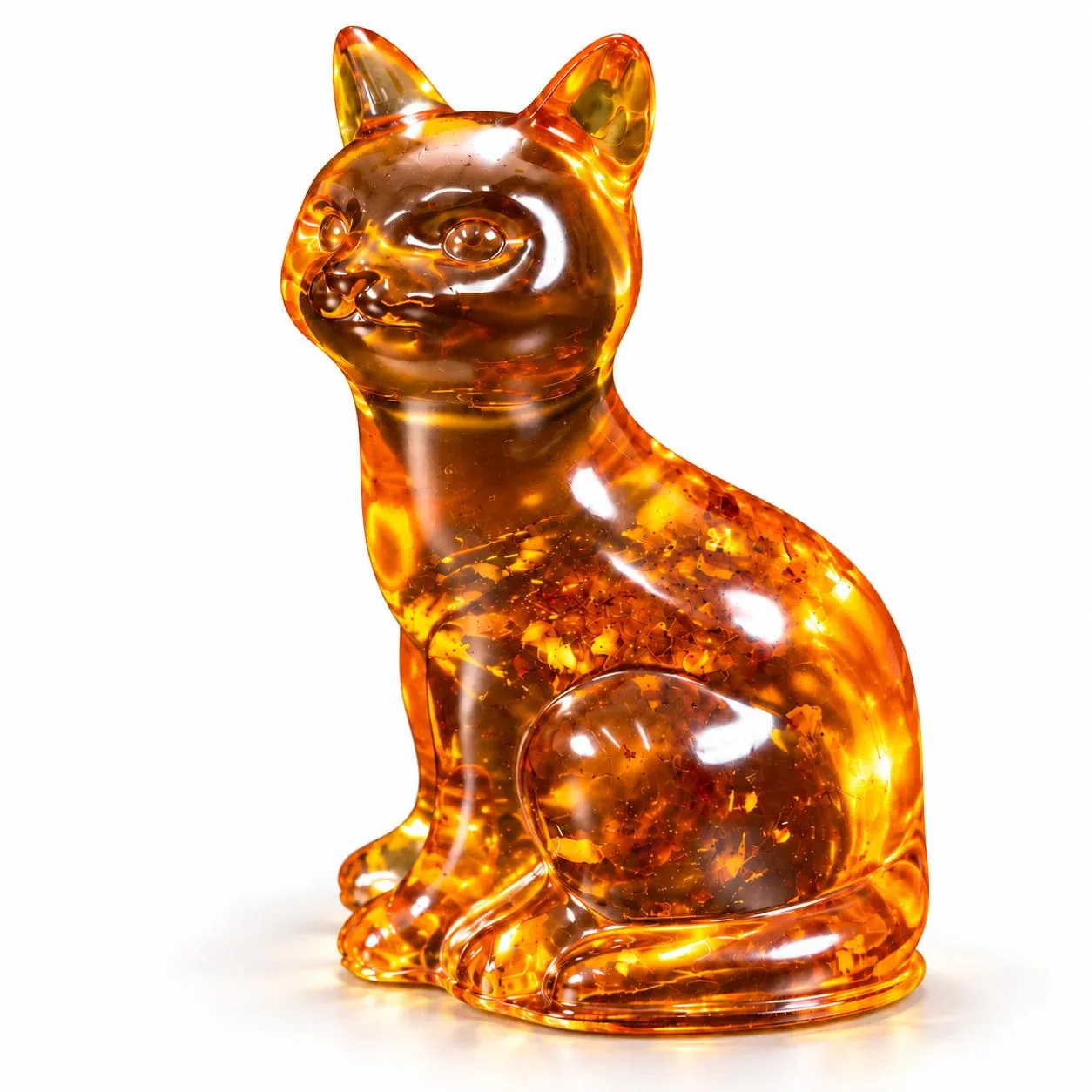 KIZIMA cognac amber sitting cat with polished highlights and natural amber inclusions on a white studio background