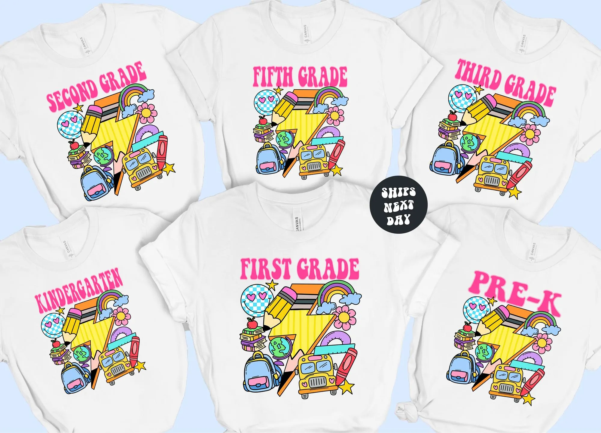 A collection of white t-shirts with colorful illustrations and text, likely representing different grade levels, such as Kindergarten, First Grade, and Third Grade.