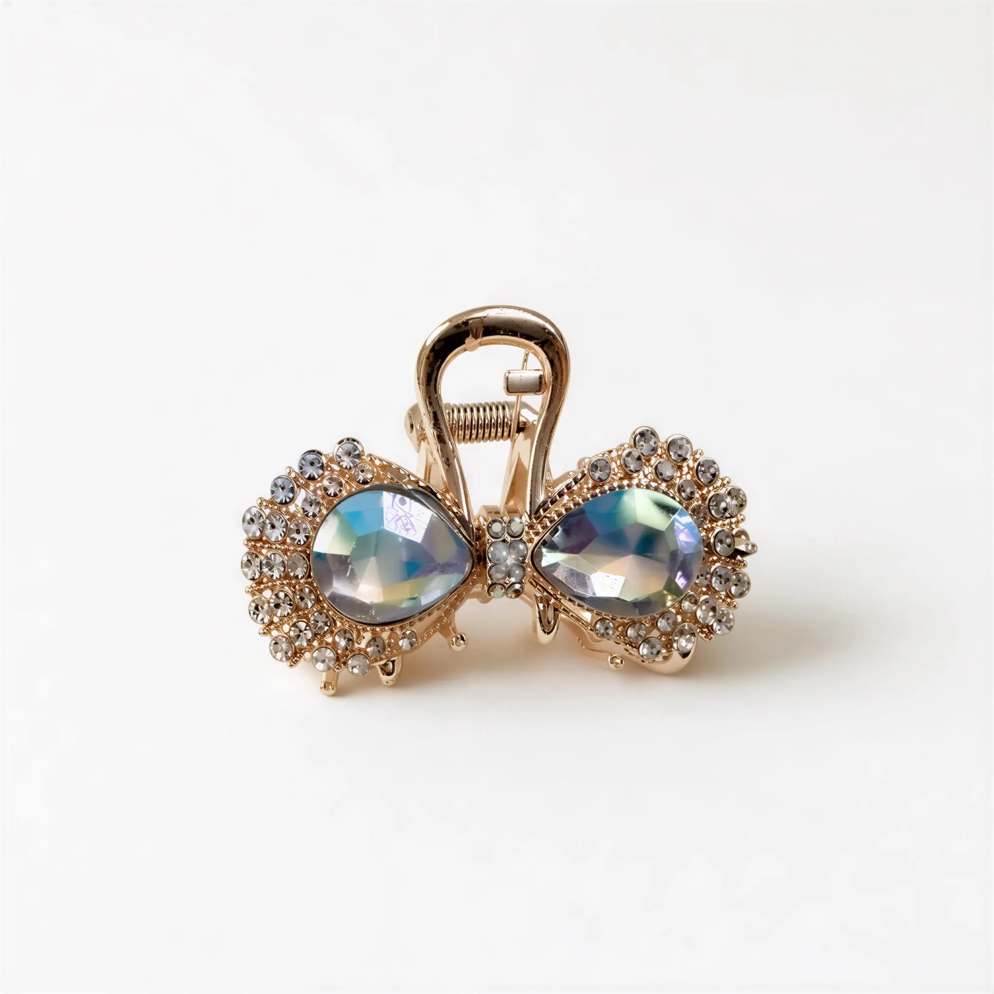 A gold-colored hair clip adorned with large, colorful gemstones.