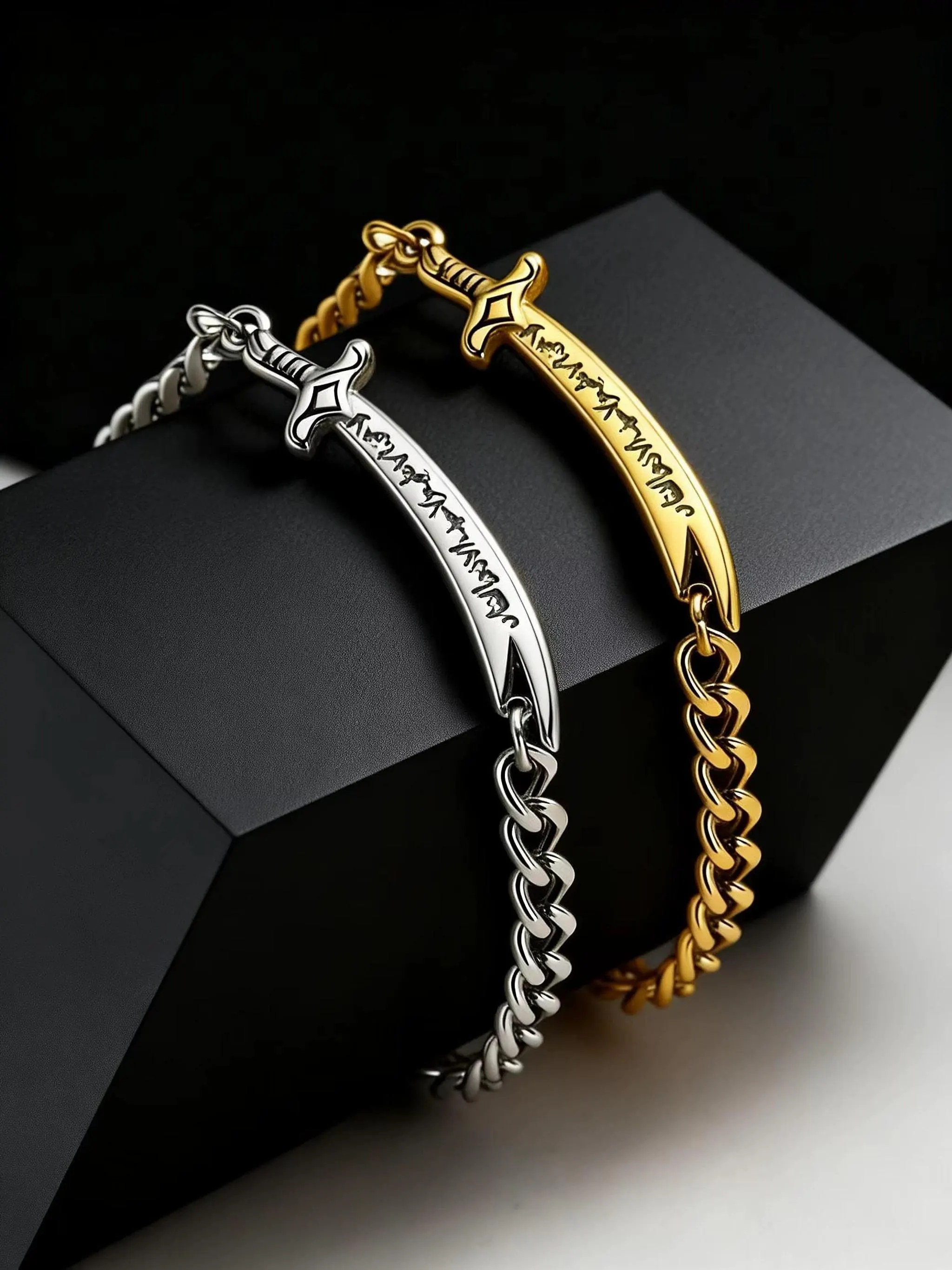 Two sword-shaped curb chain bracelets, one silver and one gold with engraved Arabic script, draped over a black display stand.
