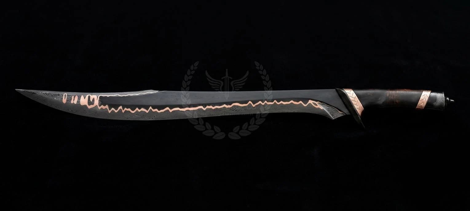 A long, curved sword with a matte black finish and a jagged, copper-coloured inlay running along the centre of the blade. The handle is dark with copper-toned metal accents at the guard and pommel, featuring a textured grip design.