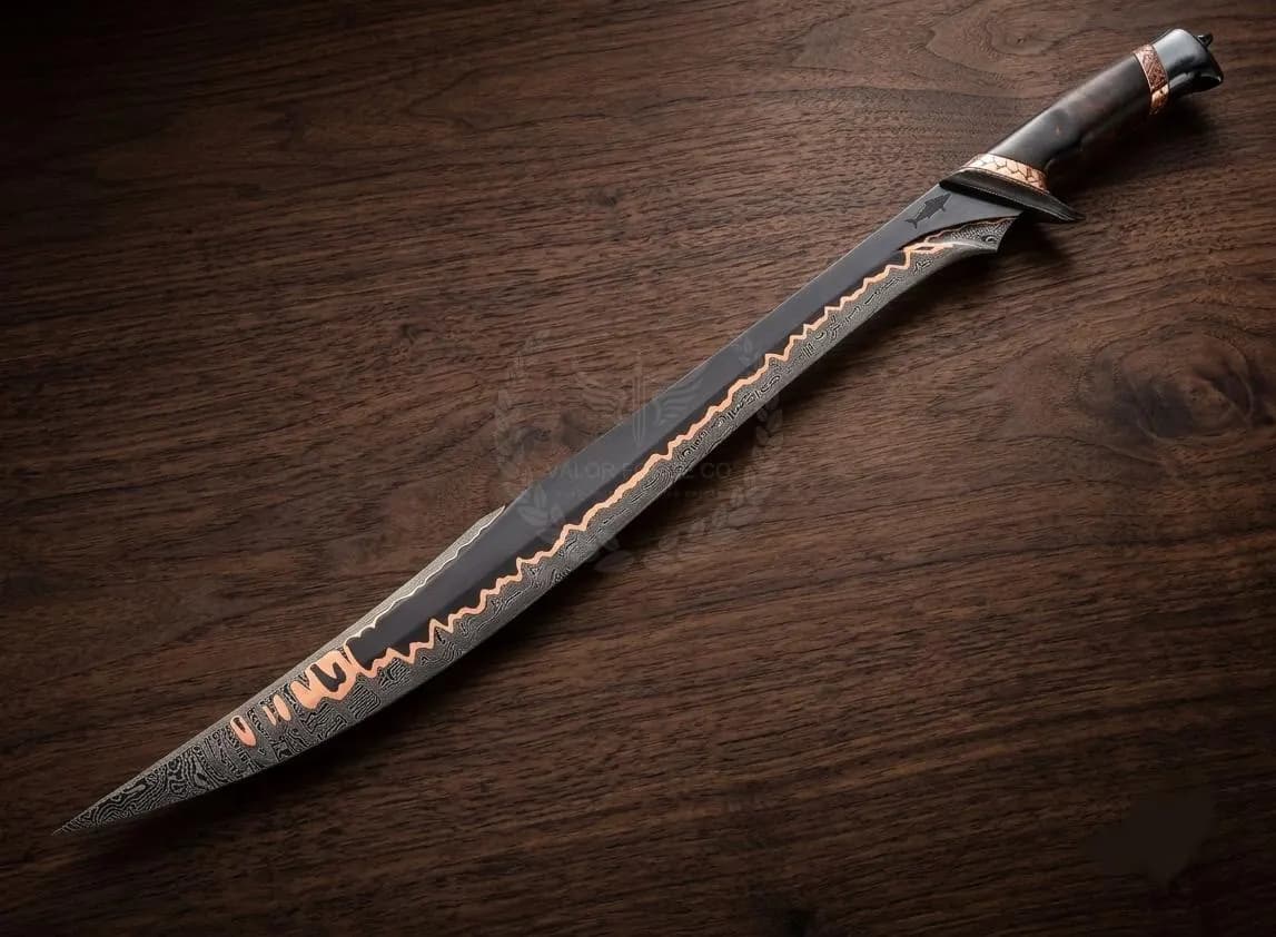 A curved blade knife featuring a dark, patterned Damascus steel finish with a prominent, jagged copper-coloured inlay running along the edge. The handle is dark with copper-coloured accents at the bolster and pommel, creating a sleek look.