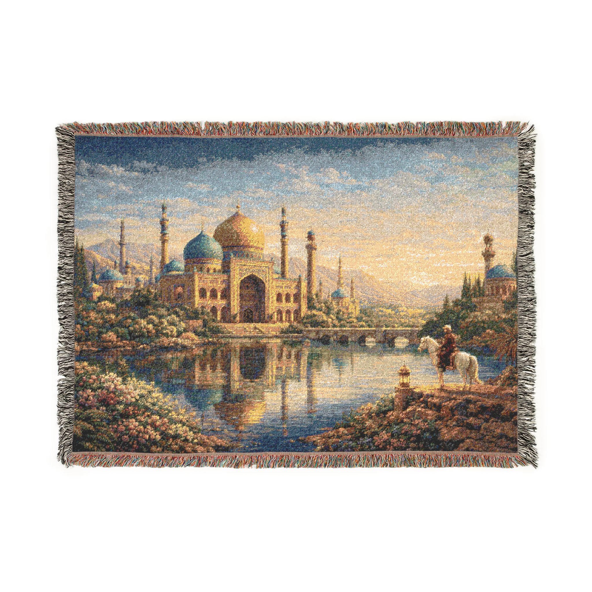 Woven tapestry wall hanging featuring a Persian inspired palace with golden dome, blue minarets, reflective lake, flower lined gardens, and a lone rider on horseback at sunset. Rich woven texture and fringe create an elegant old world look, perfect for Middle Eastern decor, Moorish wall art, maximalist bedroom decor, reading room styling, or as a woven throw blanket. Ideal for luxury vintage interiors, romantic landscape lovers, and ornate palace decor fans.
