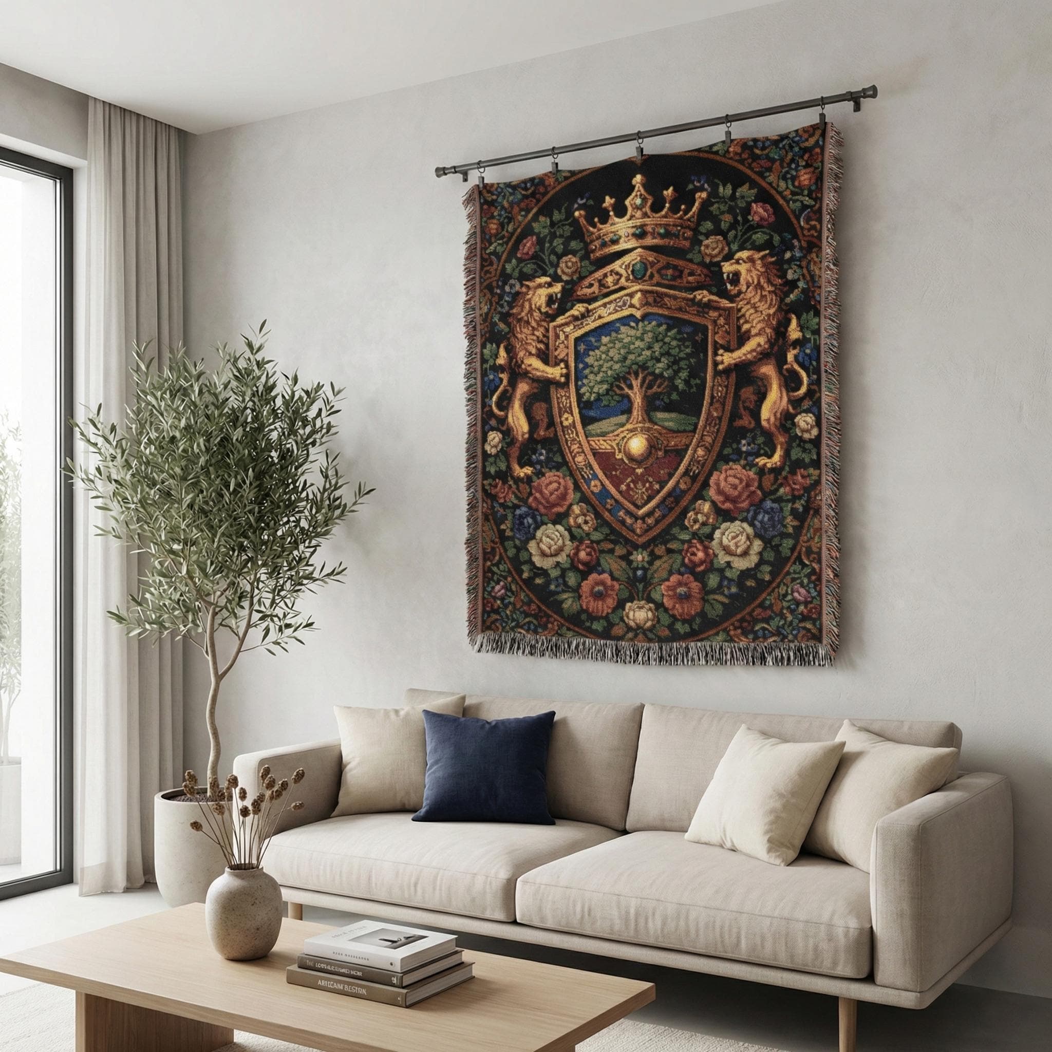 Jacquard woven tapestry blanket featuring a royal heraldic shield coat of arms with crowned lions, ornate shield crest and tree emblem, framed by a dark floral verdure border. Classic French tapestry wall hanging with fringe in rich navy, gold, burgundy, green and antique rose tones. Use as large wall tapestry for living room, bedroom, office or game room, or as a woven throw on bed or chair. Gift for castlecore decor lovers, medieval and renaissance fans, history buffs, fantasy readers.