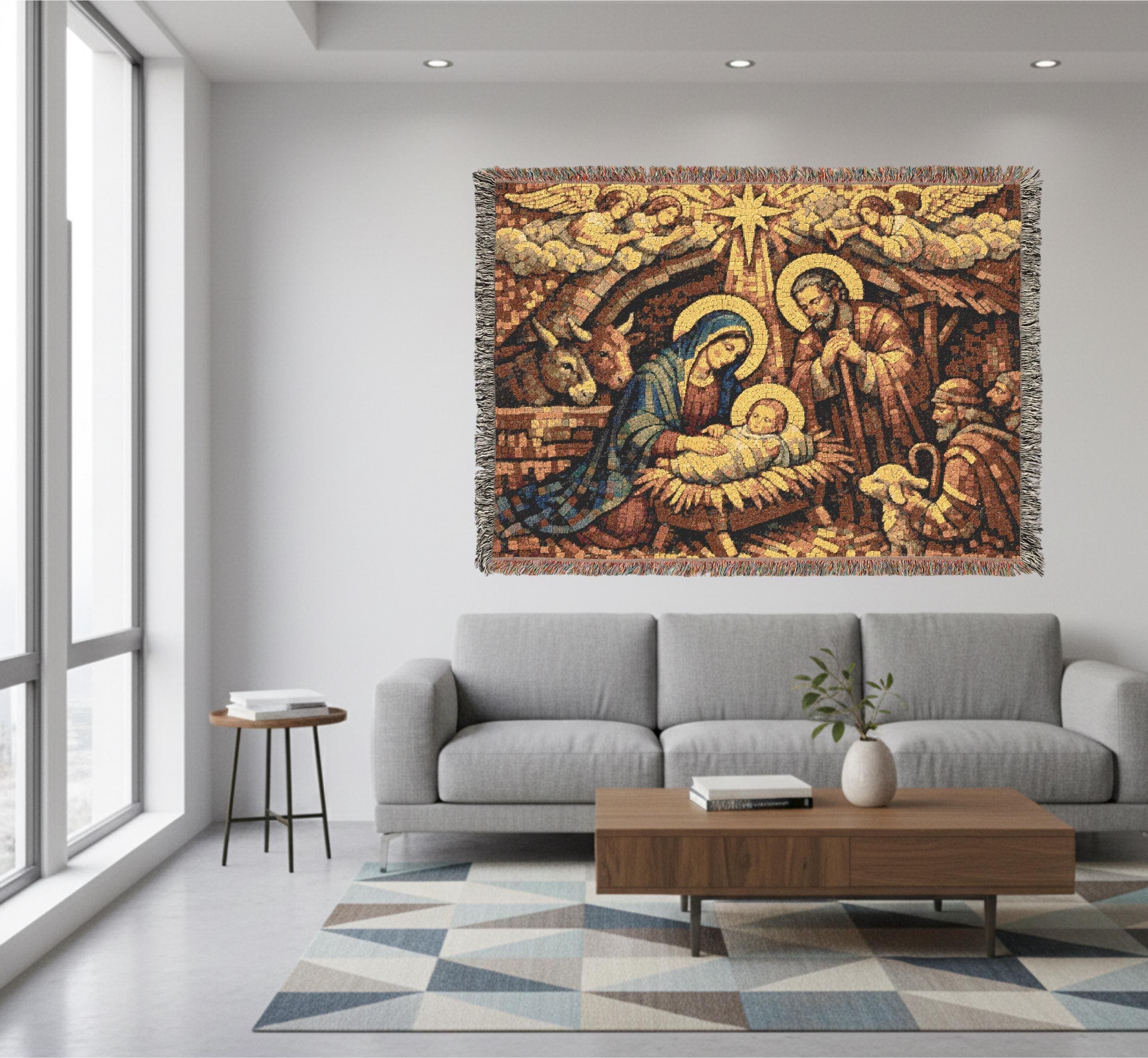 Woven tapestry blanket showing a vintage mosaic Nativity scene: Mary in a blue robe and Joseph kneeling beside baby Jesus in a manger, under the Star of Bethlehem with angels above, a shepherd, lamb, and donkey in the stable. Warm gold and earthy tones with fringed edges. Style as Christmas tapestry wall art, Holy Family wall hanging, classic wall tapestry decor for mantel, entryway, bedroom, nursery, prayer corner, or church, and a meaningful holiday gift for believers.