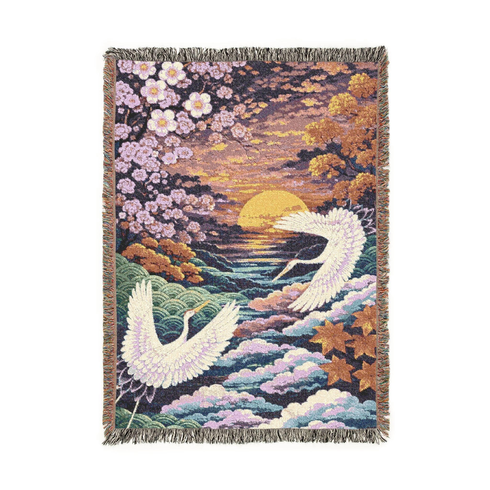 Woven tapestry wall hanging featuring two white Japanese cranes flying over layered clouds and ocean waves at sunset, framed by cherry blossoms and autumn leaves in soft pink, gold, teal, and lavender tones. Serene Asian landscape wall decor with rich woven texture and fringe, ideal for bedroom, living room, reading nook, meditation room, or zen corner. works as a woven throw blanket. Beautiful gift for bird lovers, Japanese decor fans, housewarmings, and peaceful nature-inspired home styling