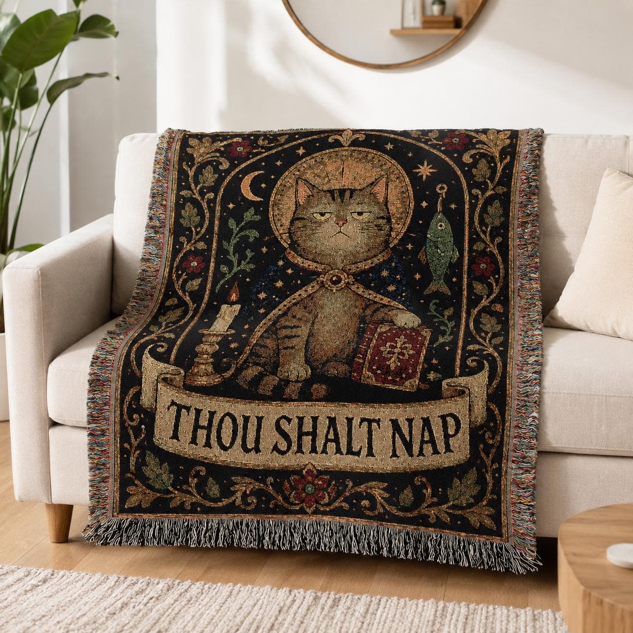 Funny cat tapestry wall hanging showing a grumpy medieval cat with a halo, candle, fish, red book, moon, stars, floral border, fringe, and the phrase Thou Shalt Nap in dark black, antique gold, muted green, burgundy, and cream woven texture.