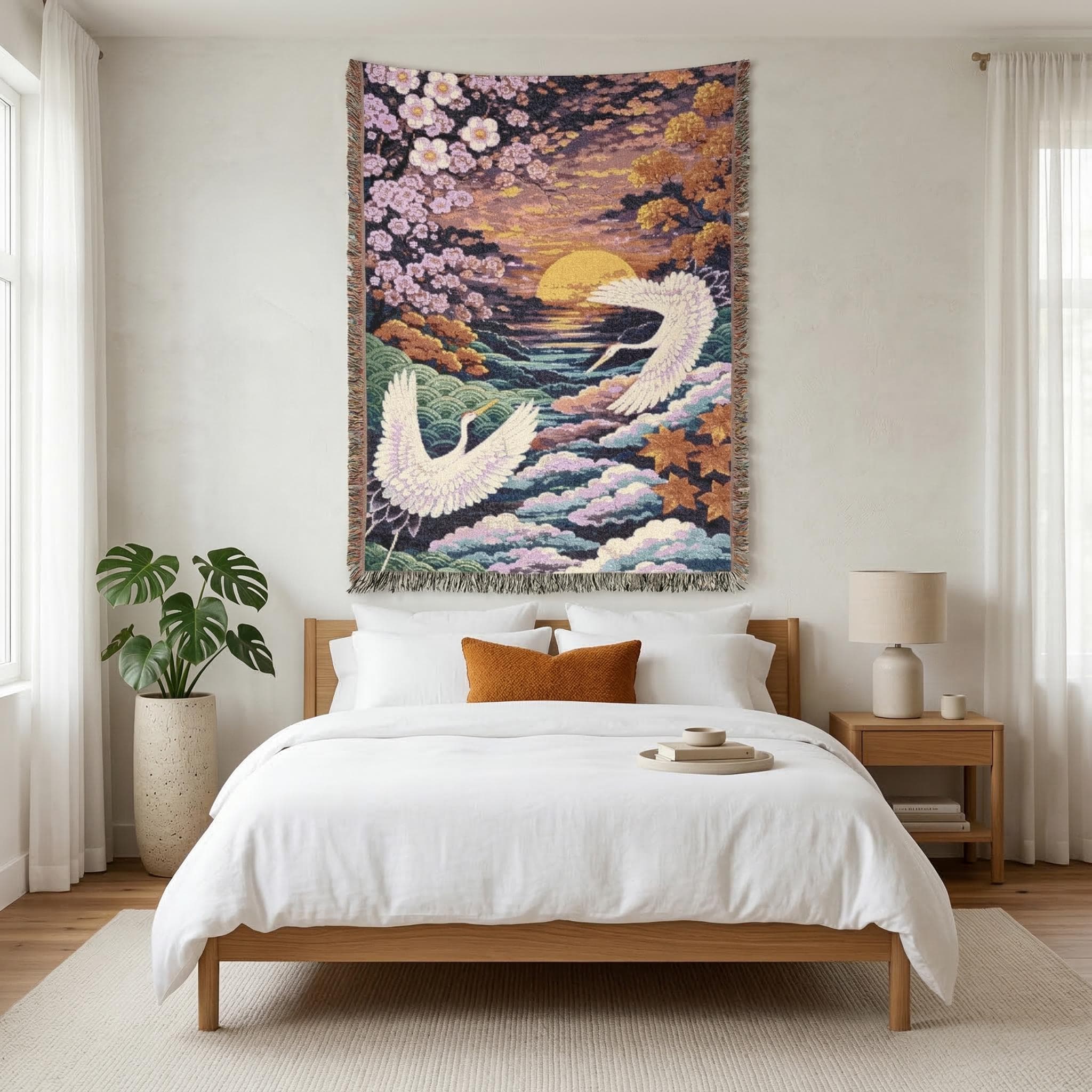 Woven tapestry wall hanging featuring two white Japanese cranes flying over layered clouds and ocean waves at sunset, framed by cherry blossoms and autumn leaves in soft pink, gold, teal, and lavender tones. Serene Asian landscape wall decor with rich woven texture and fringe, ideal for bedroom, living room, reading nook, meditation room, or zen corner. works as a woven throw blanket. Beautiful gift for bird lovers, Japanese decor fans, housewarmings, and peaceful nature-inspired home styling