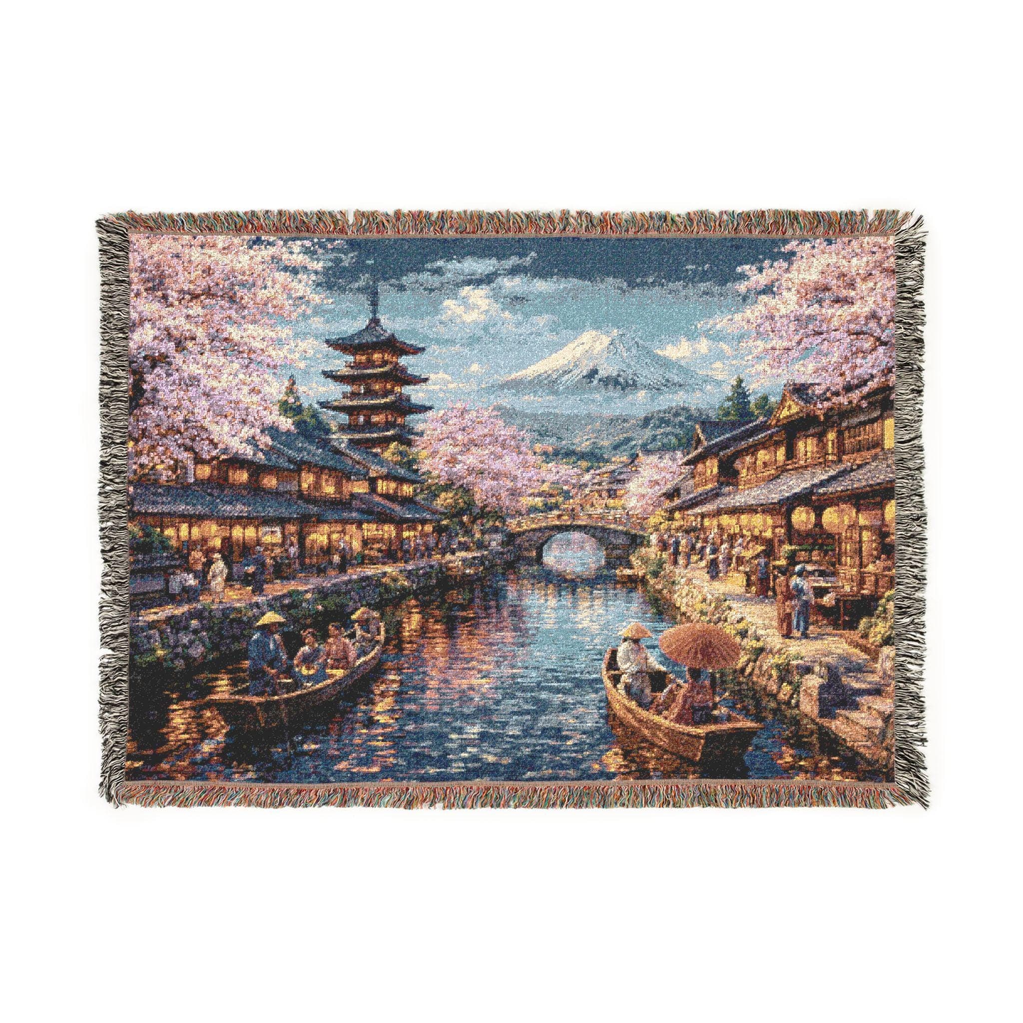 Woven tapestry wall hanging featuring a romantic Japanese canal village with glowing traditional houses, blooming cherry blossom trees, small wooden boats, a pagoda, an arched stone bridge, and Mount Fuji in the distance beneath a soft evening sky. Scenic sakura wall art with warm water reflections and timeless travel charm, ideal as a large wall tapestry, woven throw blanket, Japanese home decor, peaceful room accent, and gift for cherry blossom lovers and landscape art collectors.