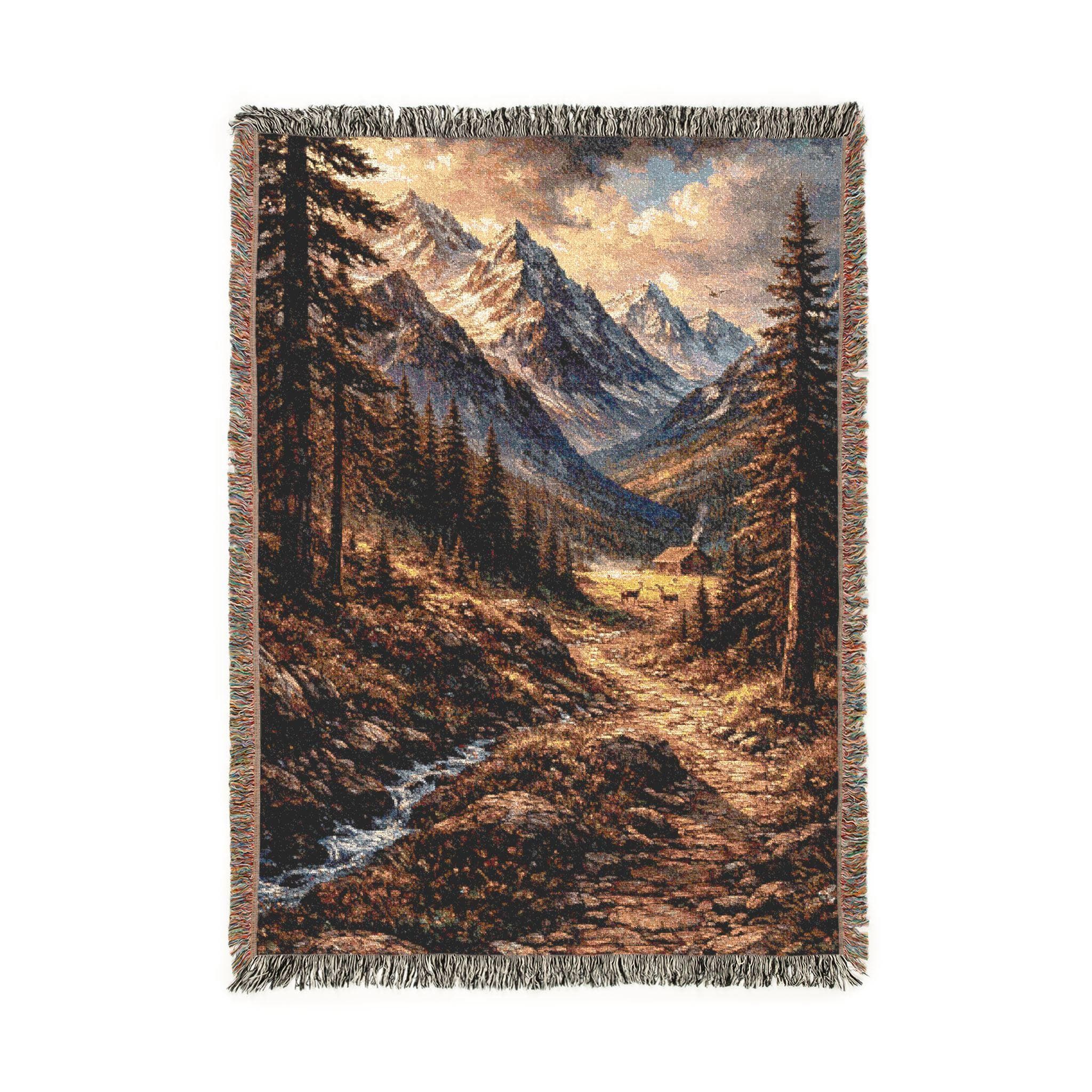 Jacquard woven tapestry throw blanket with fringe, vertical mountain landscape showing a winding trail through pine forest, rocky creek, and golden sunset light on snowcapped peaks. Cozy cabin tucked in the valley with meadow glow, rustic lodge wall hanging look for cabin decor, mountain home, or cozy living room. Perfect gift for hikers, campers, outdoor lovers, and nature photography fans; use as large wall tapestry, couch throw, or classic woven tapestry art accent.