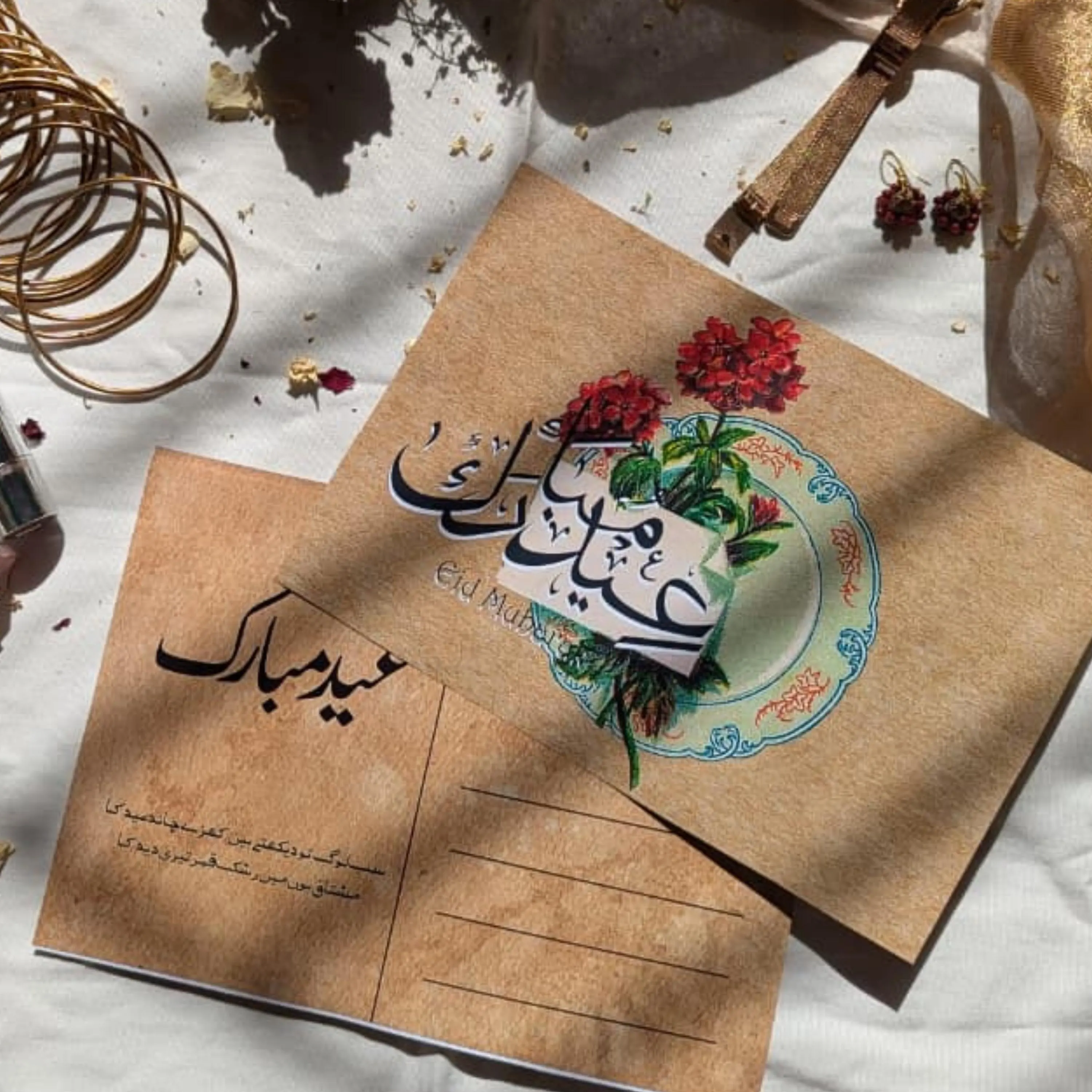 Flatlay of Islamic greeting card with red floral botanical and Arabic script