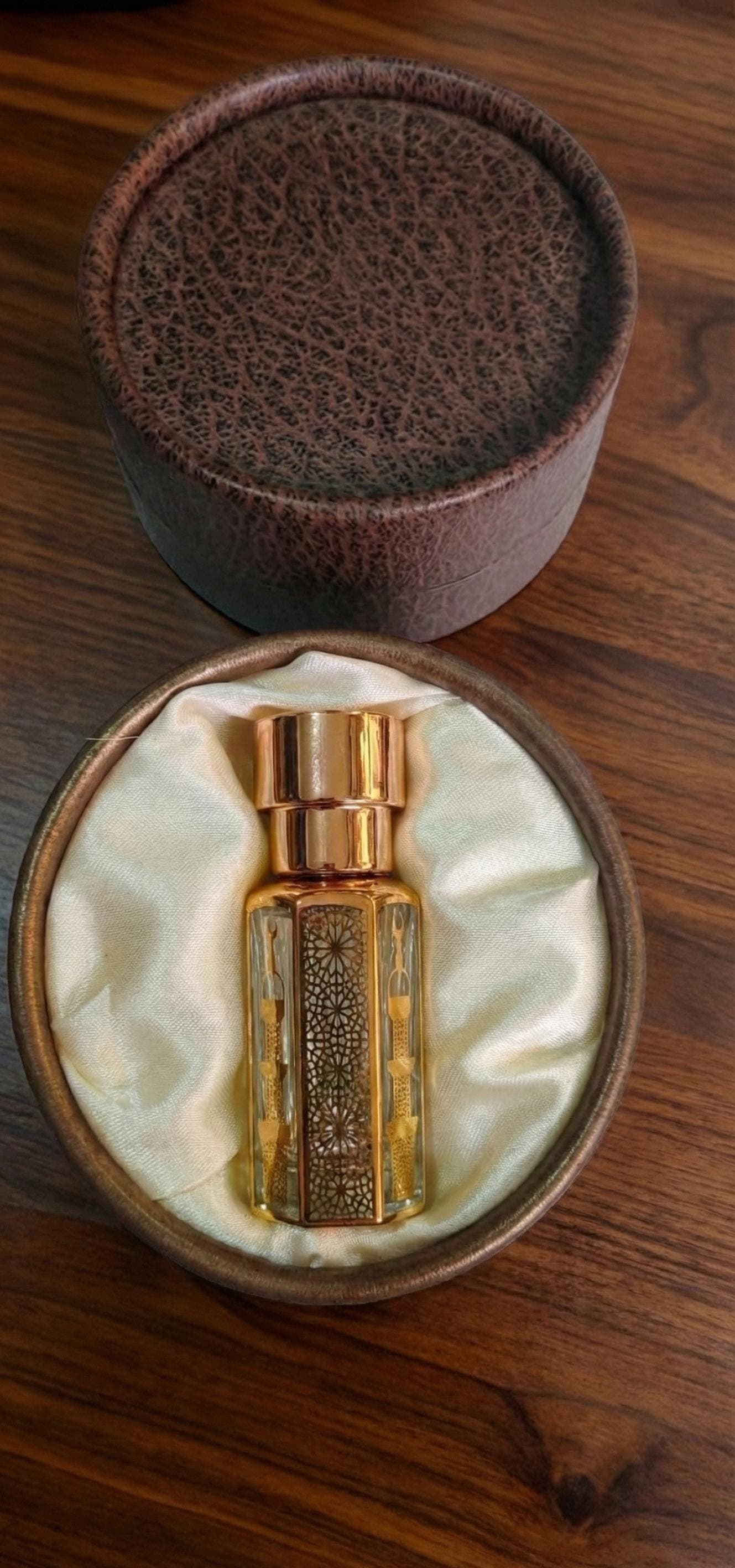 Assam Oud perfume oil with oud wood and incense smoke, traditional Indian smoky woody attar fragrance
