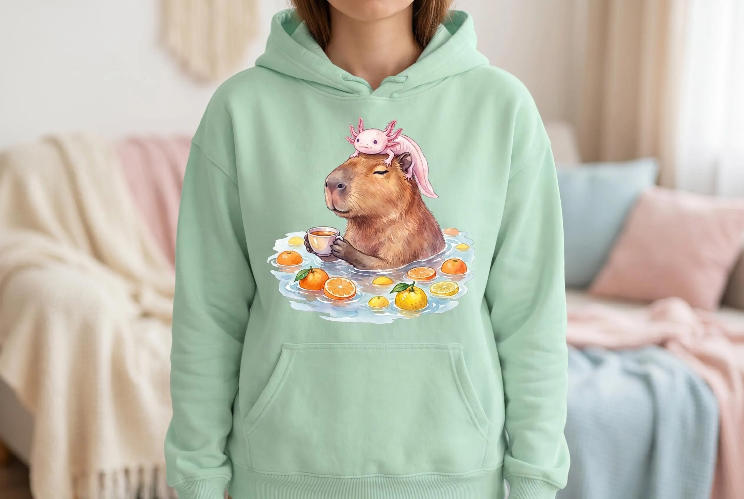Hoodie with Capybara Axolotl PNG — watercolor capybara in a citrus bath holding a tea cup with a pink axolotl on its head, "Capy-Lotl Relax Station" pink gradient arch text above. Funny meme shirt capybara designs placement example.