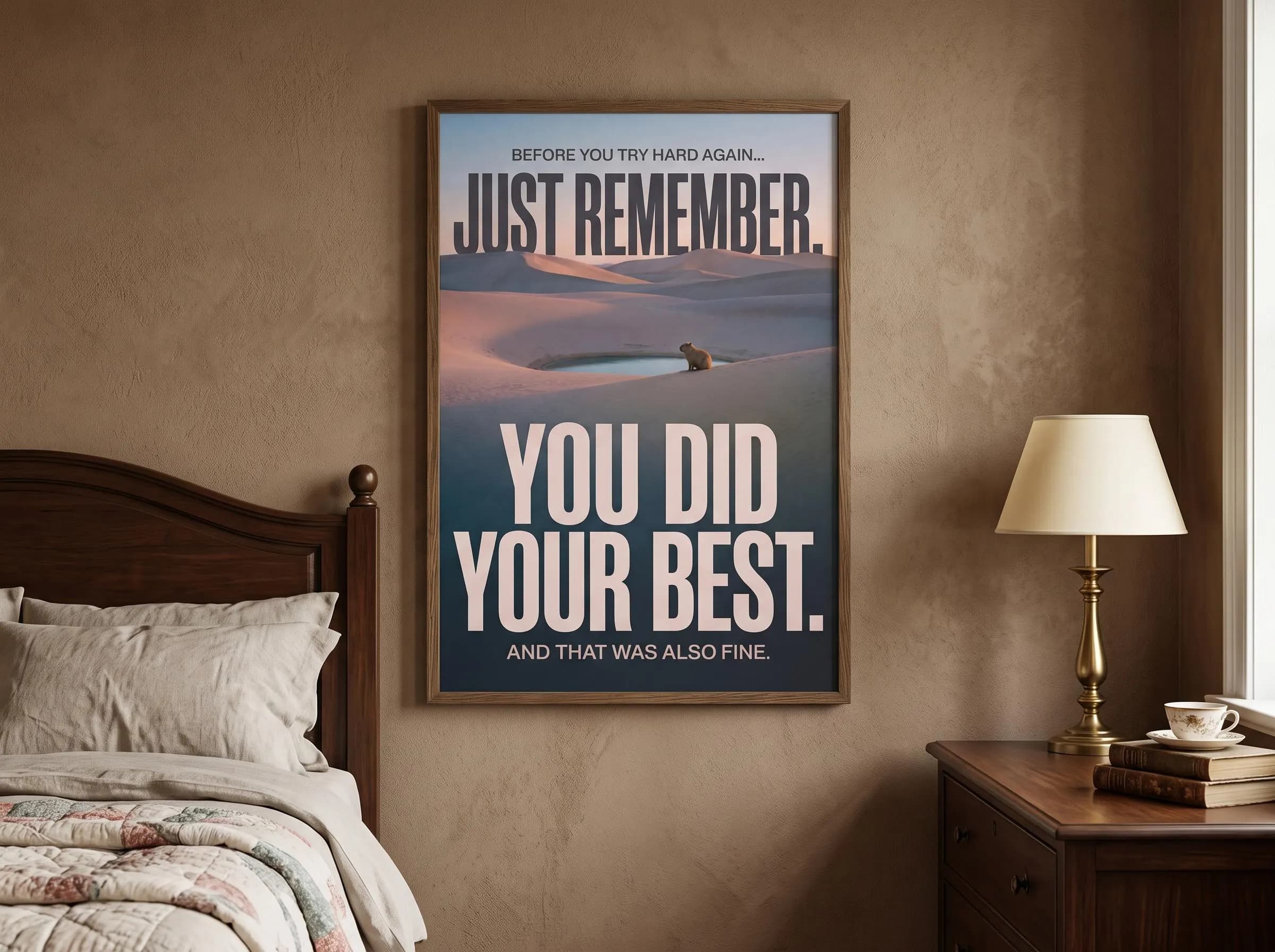 Philosophy poster deadpan quote print featuring a capybara beside a mirror-still oasis in warm sand dunes. Elegant cream typography turns effort-guilt into acceptance. A desert art landscape print with dusk tones of coral, sand, and dusky slate.