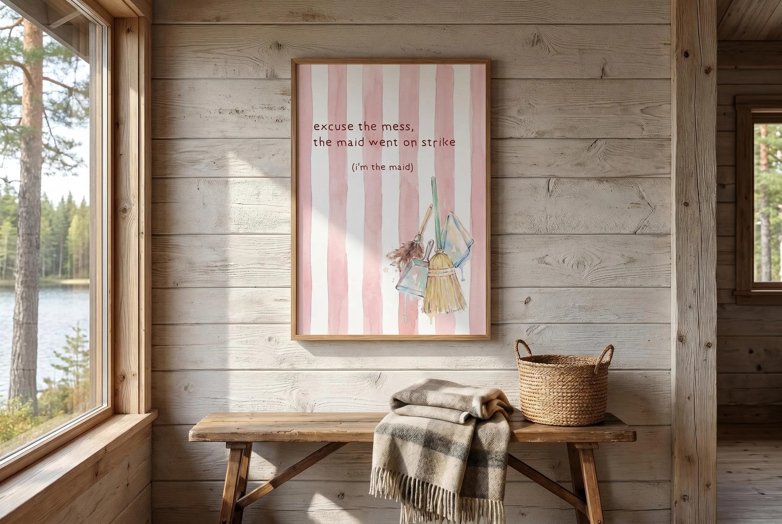 Minimalist print "excuse the mess, the maid went on strike (i'm the maid)" typography on pink white striped background, cleaning supplies hanging (blue mop, yellow broom, dustpan). Trending now pink wall art dopamine decor hand drawn poster gift for yourself.