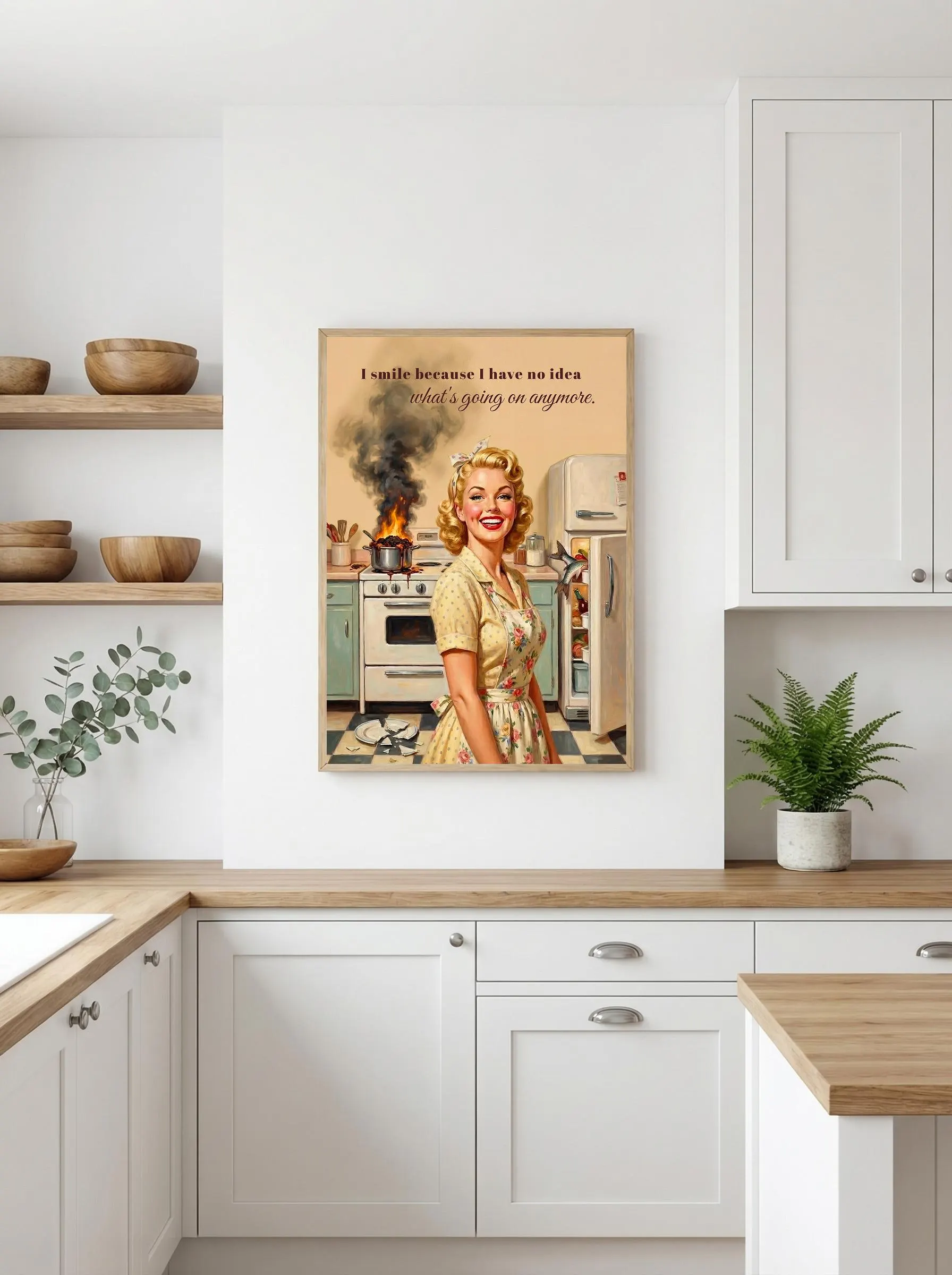 Vintage pin up poster with 1950s housewife in yellow floral print dress, blonde curls, red lipstick, smiling in retro kitchen. Pan on fire with black smoke on stove behind. "I smile because I have no idea what's going on anymore." script typography. Beige backdrop, vintage appliances.
