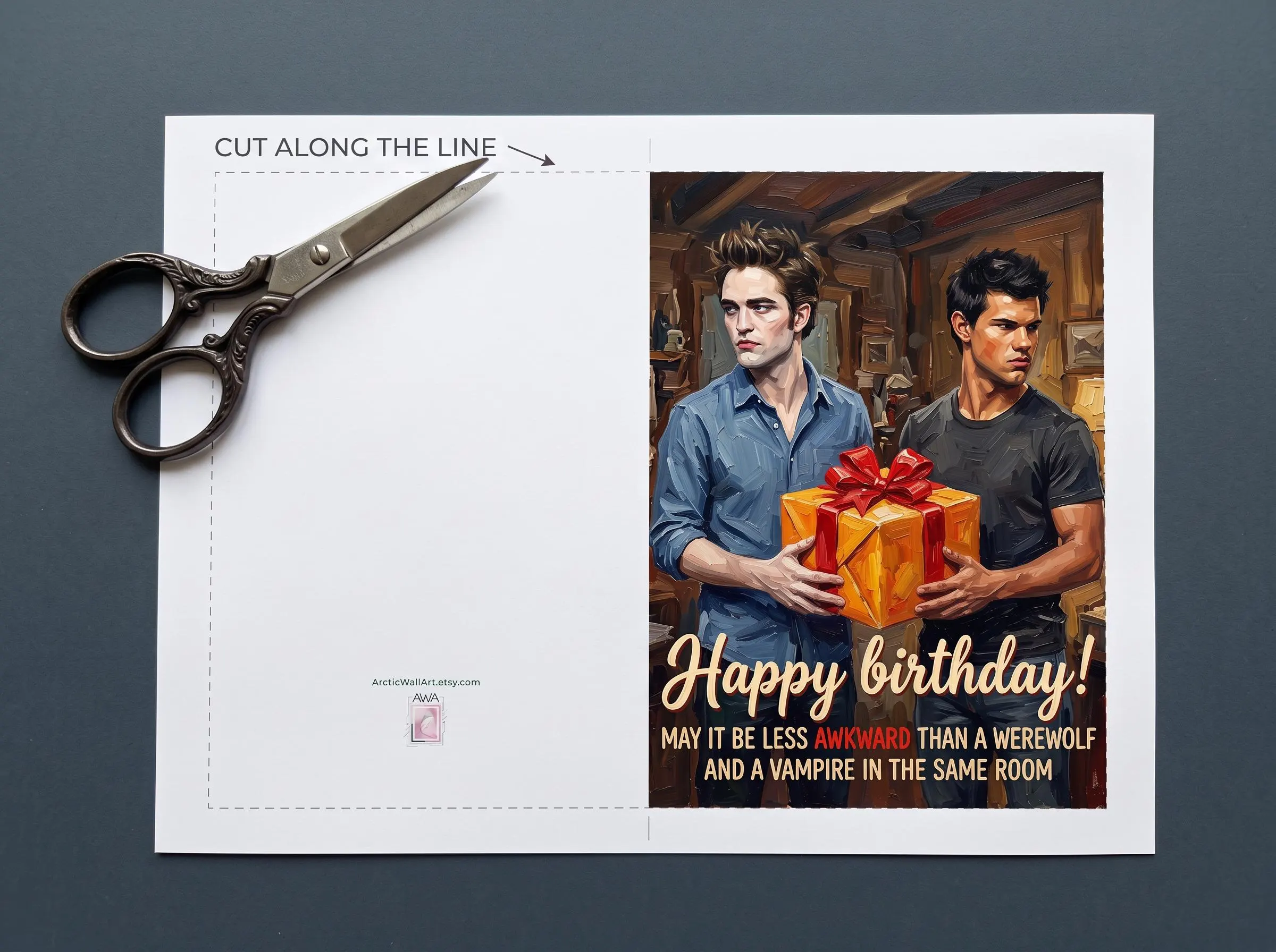 Postcard digital layout of the Twilight birthday card before cutting: a dashed cut line around the card, a blank back panel with a small ArcticWallArt mark, and a front with Edward Cullen and Jacob Black awkwardly sharing one birthday gift, with the text Happy birthday! May it be less awkward than a werewolf and a vampire in the same room. Print, cut and fold into a 5 x 7 inch card.