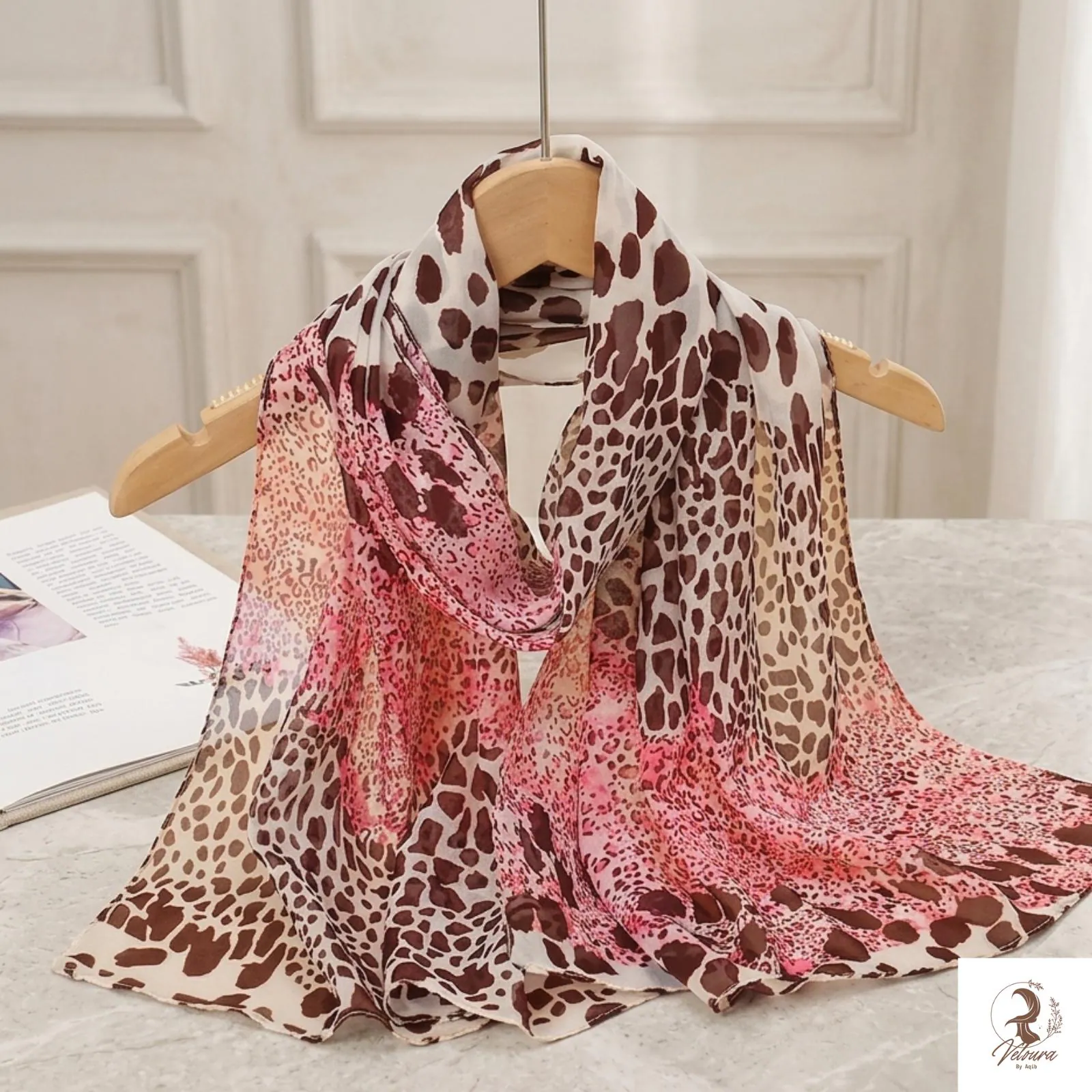 Lightweight printed scarf folded to showcase floral details.