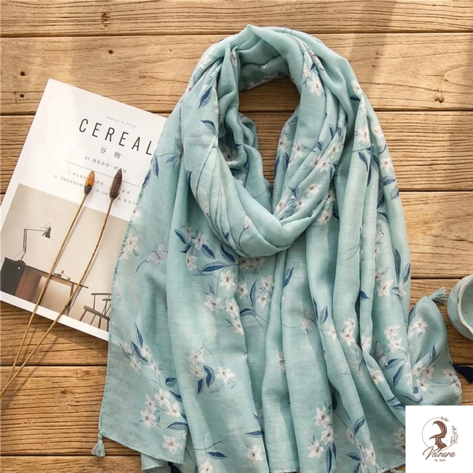 Cotton shawl styled as a wrap with decorative tassel details