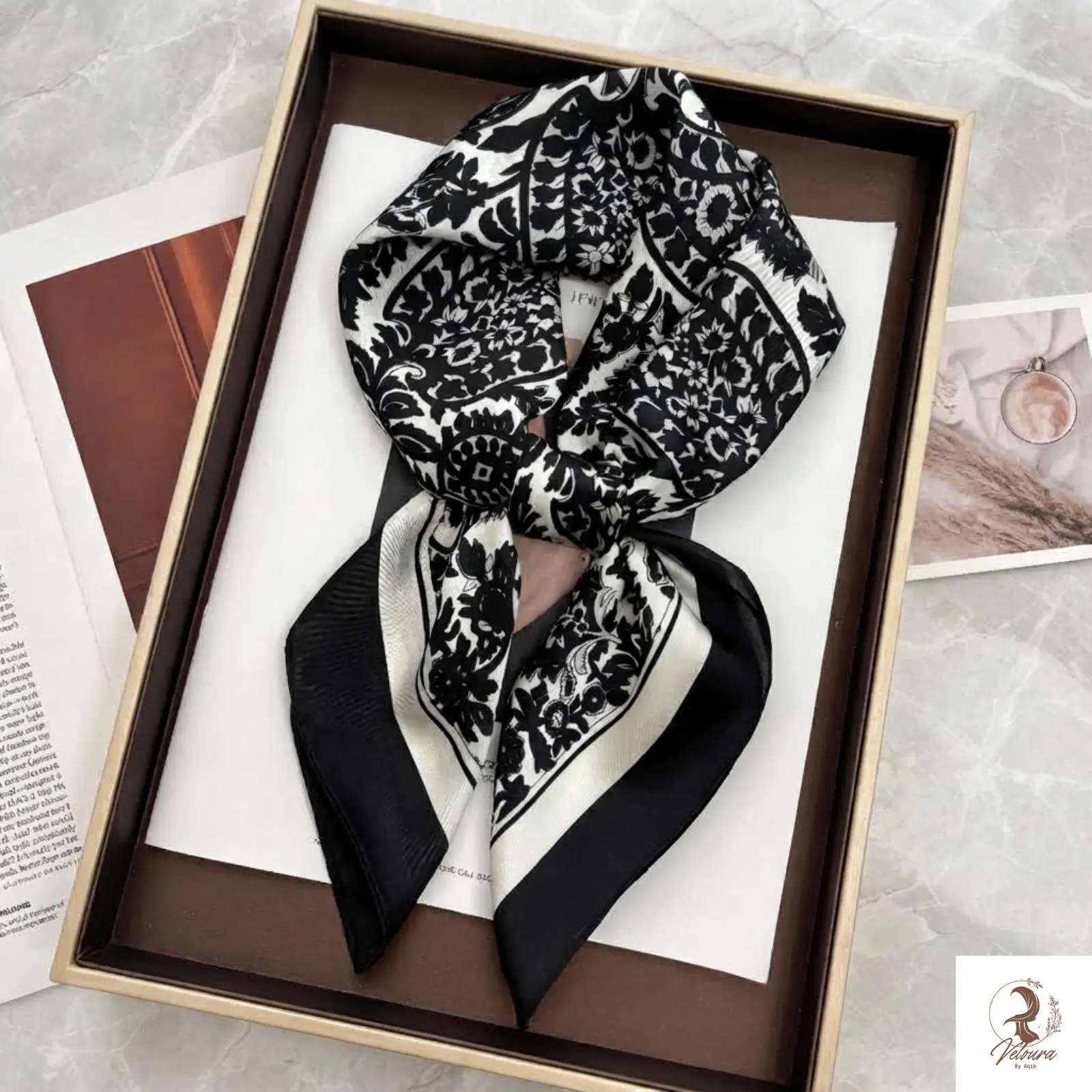 Printed square scarf worn as a stylish head wrap