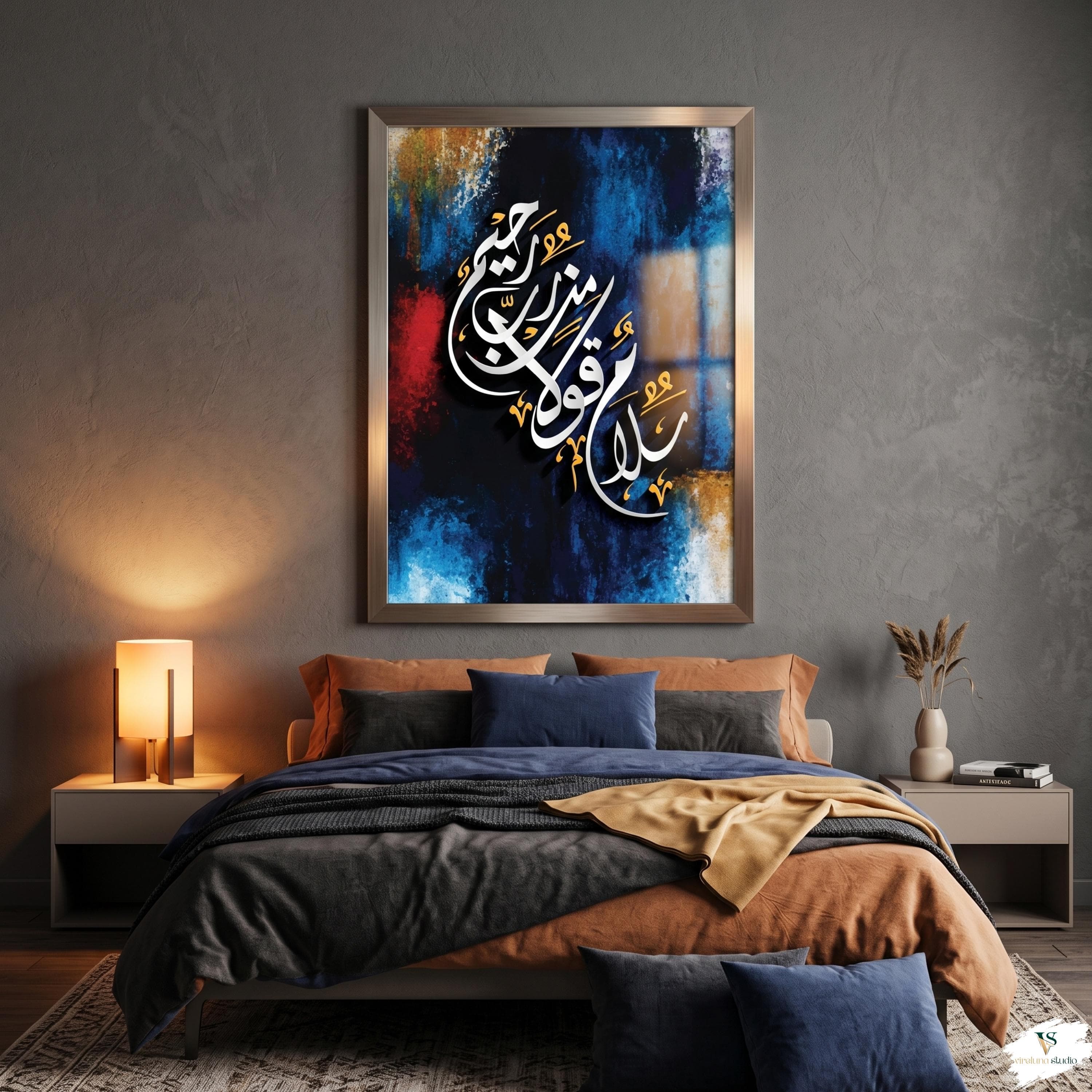 Modern Islamic wall art featuring Salamun Qaulam Min Rabbir Raheem Arabic calligraphy in white over a vibrant blue, red, and gold abstract oil paint background. The art is displayed in a large light wood frame on a white wall in a bright, modern living room next to a grey armchair and green plants.