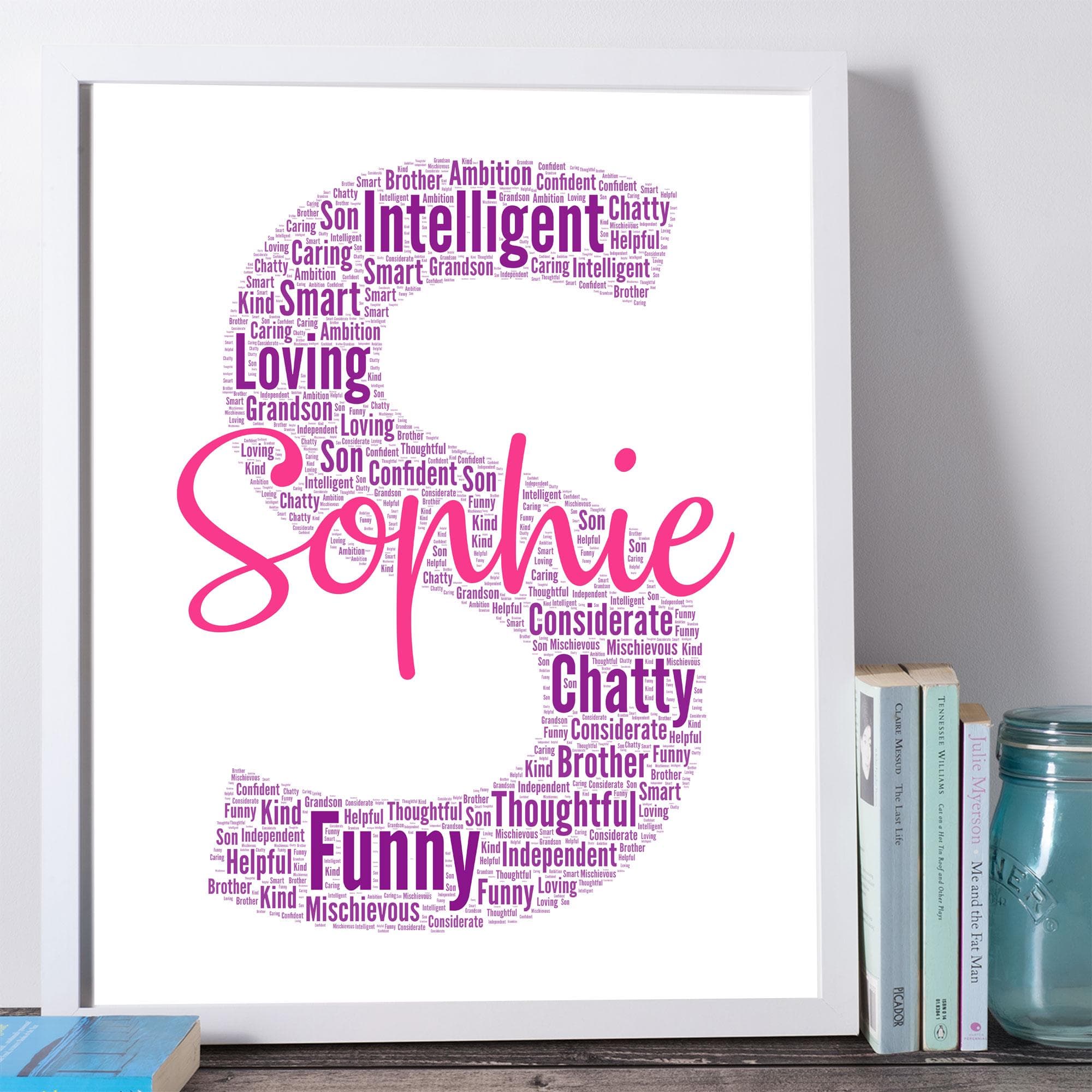 Personalised initial silhouette wall art created from custom words and names, displayed in a modern white wooden frame on a colourful nursery wall