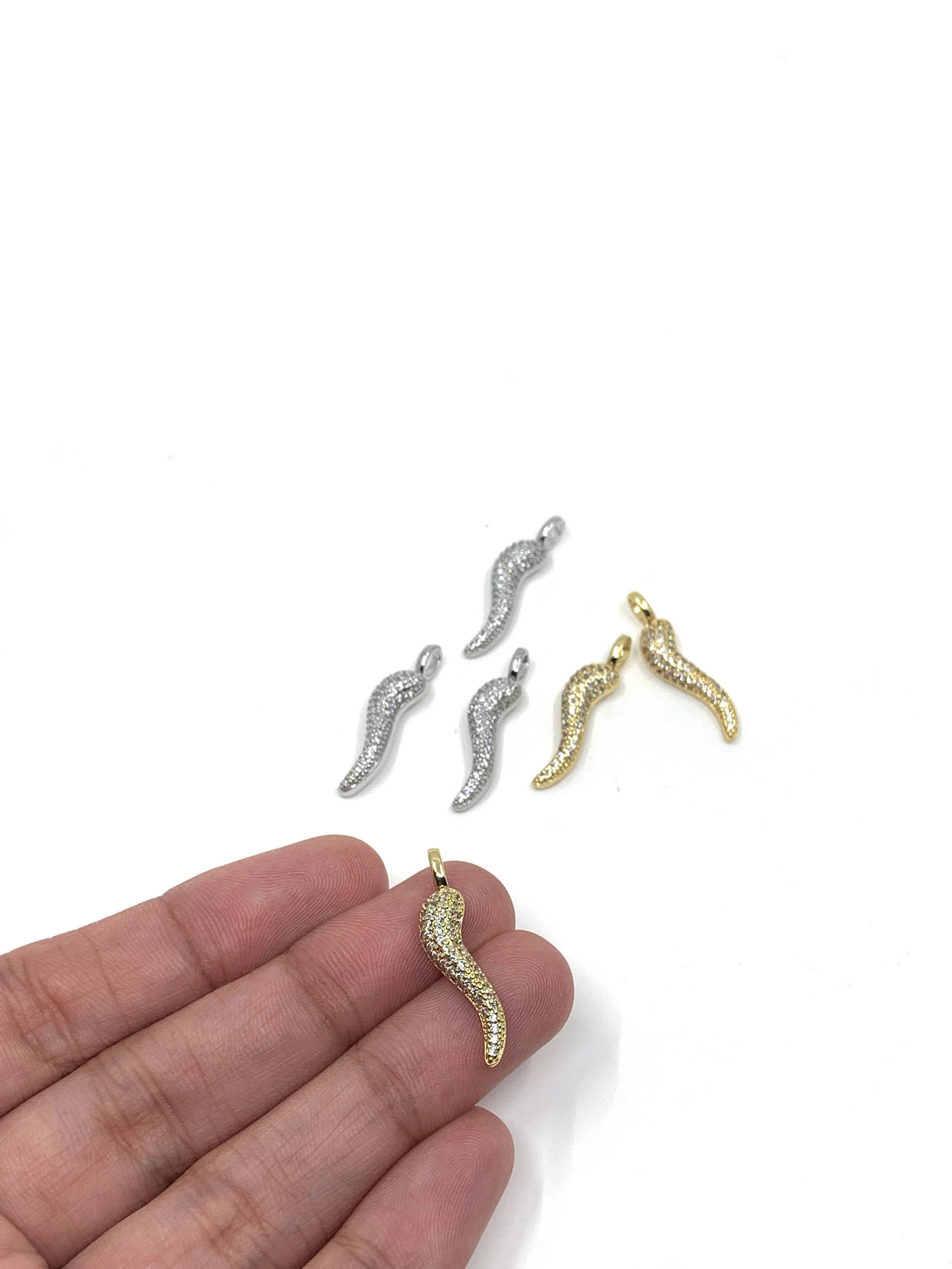 Italian horn charms shown on hand for reference