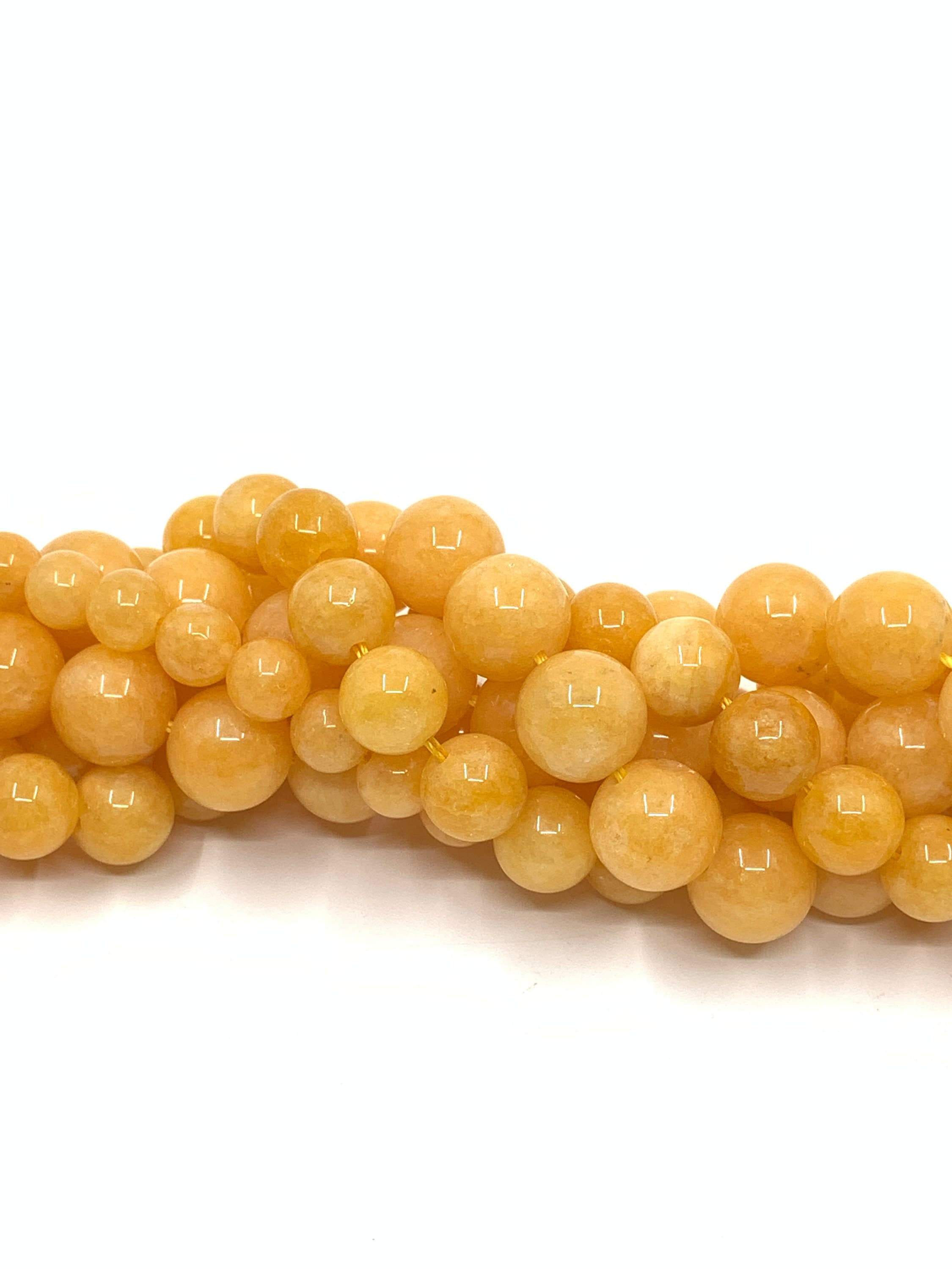 Milky yellow jade beads twisted onto each other to show color